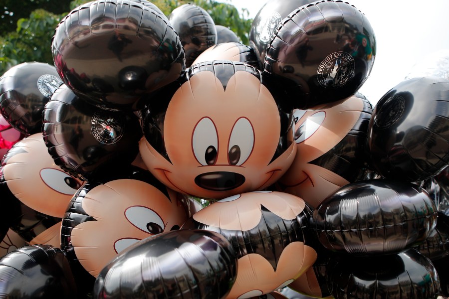 FILE - Mickey Mouse balloons are displayed at Disneyland Paris in Chessy, France, June 8, 2018. (AP Photo/Francois Mori, File)
