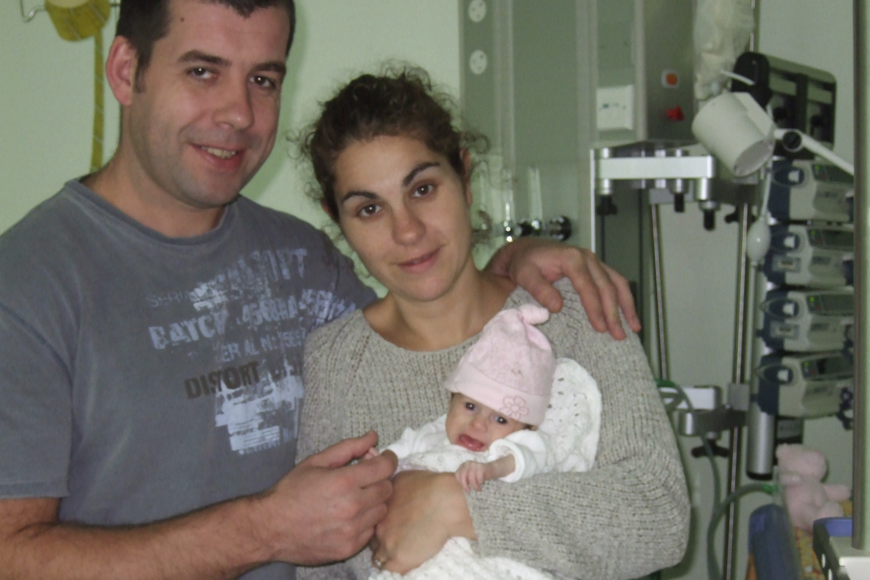 In this photo provided by the Lily Foundation, Dave Merritt and Liz Curtis, of England, hold their daughter, Lily, who died of a mitochondrial disease in 2006 at 8-months old. (Lily Foundation via AP)