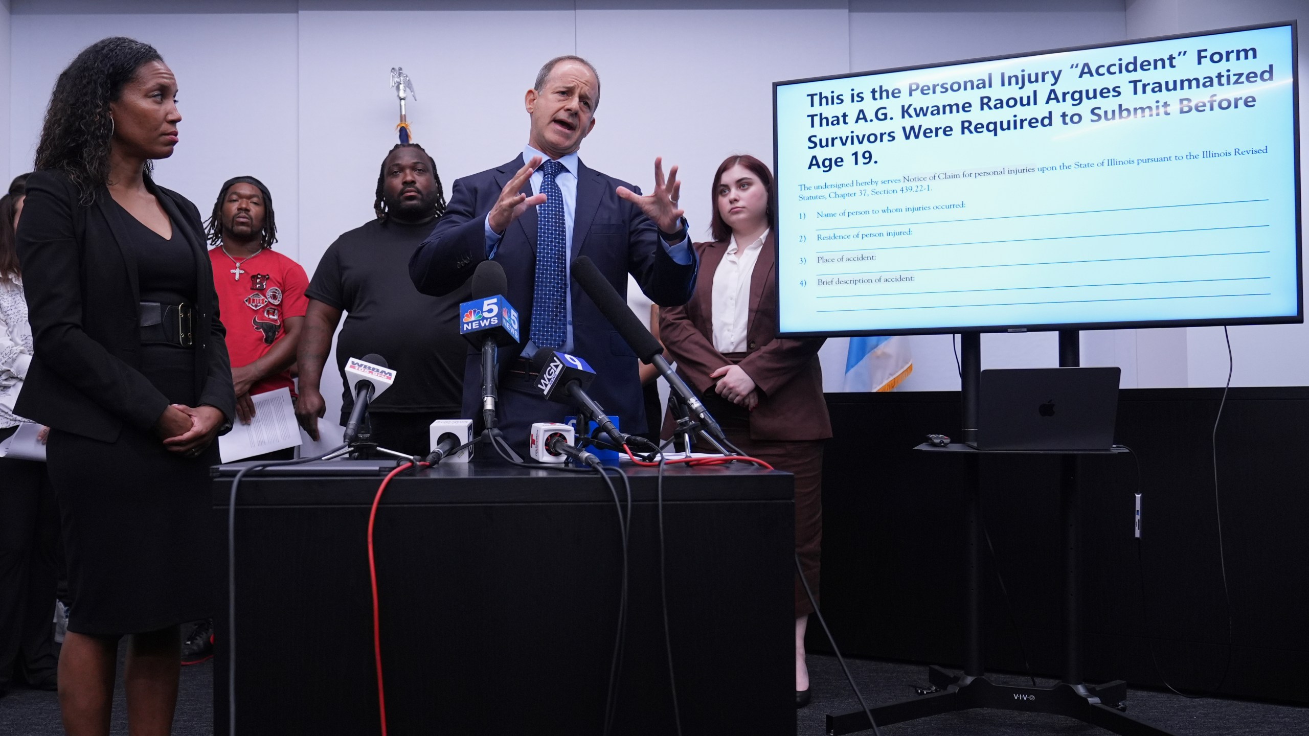 Jerome Block, partner, Levy & Konigsberg LLP, right, talks to media as attorney Kristen Feden, 1st left, listens to him during a news conference in Chicago, Wednesday, July 16, 2025. (AP Photo/Nam Y. Huh)