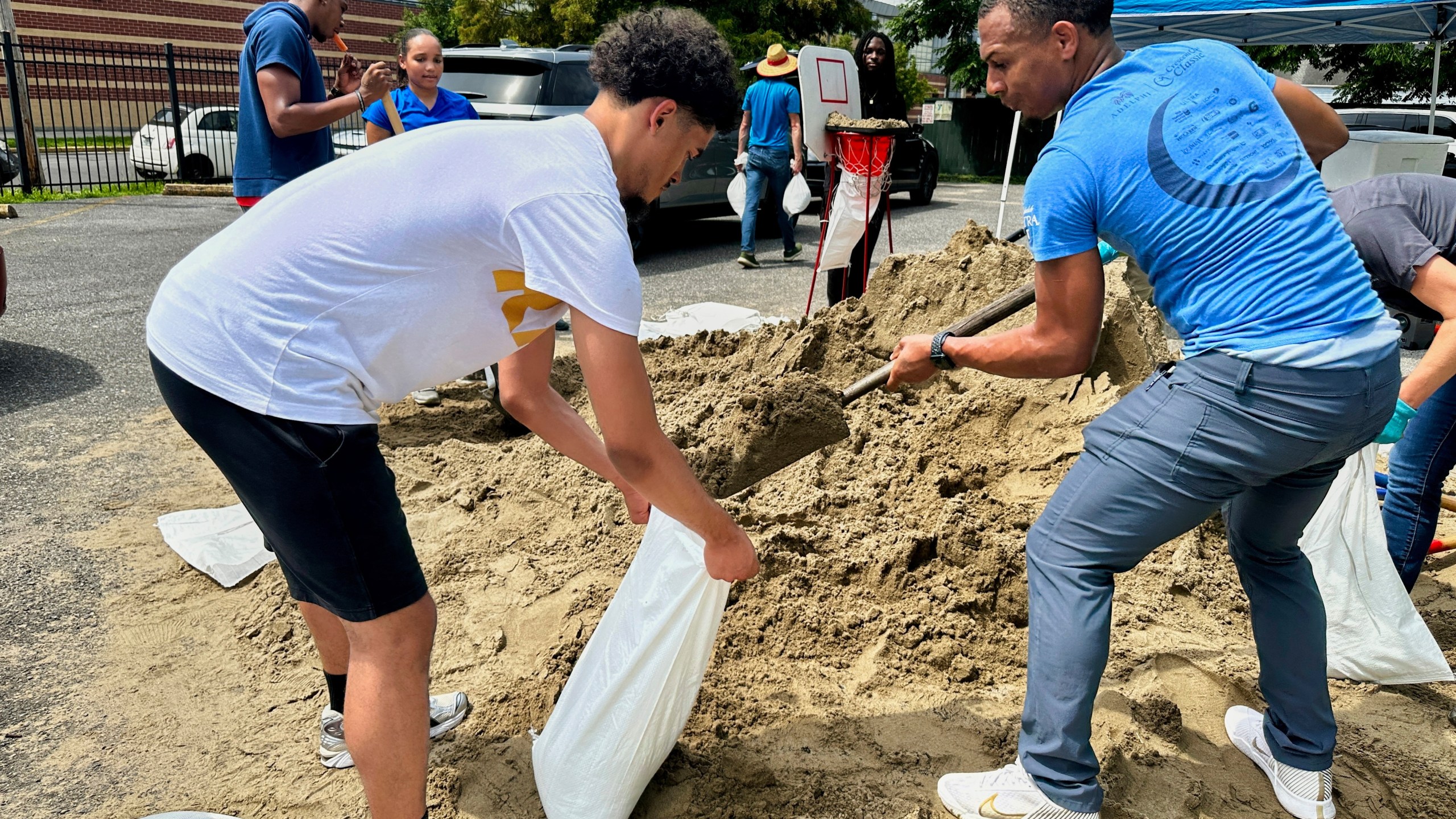 Volunteers fill sandbags for New Orleans residents, Wednesday, July 16, 2025, anticipating heavy rain from a tropical weather system moving toward the Gulf Coast. (AP Photo/Stephen Smith)