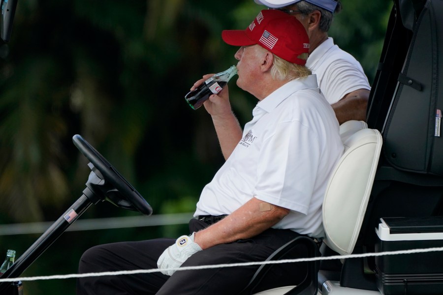 FILE - Former President Donald Trump drinks a Diet Coke during the ProAm of the LIV Golf Team Championship at Trump National Doral Golf Club, Oct. 27, 2022, in Doral, Fla. (AP Photo/Lynne Sladky, File)