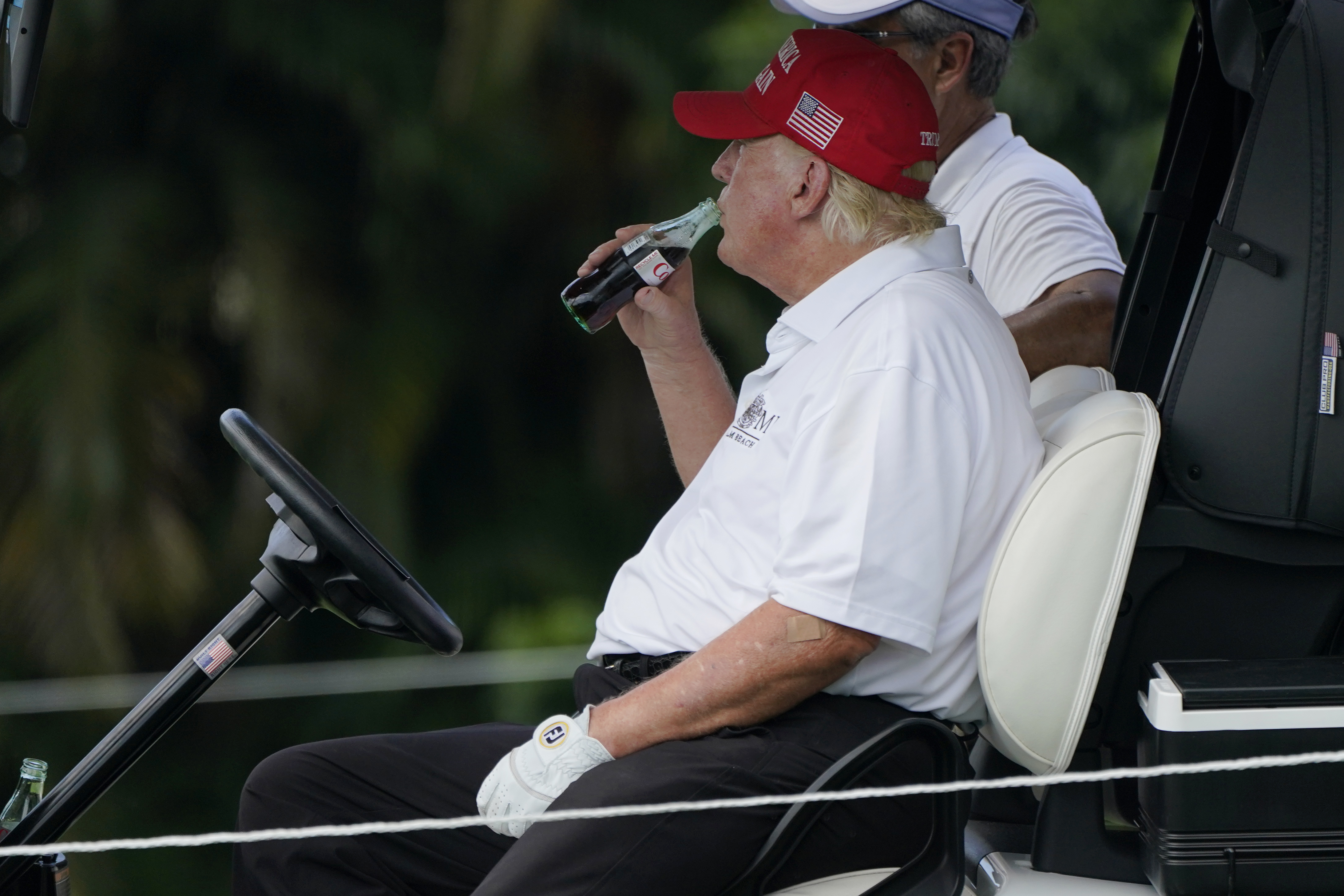 FILE - Former President Donald Trump drinks a Diet Coke during the ProAm of the LIV Golf Team Championship at Trump National Doral Golf Club, Oct. 27, 2022, in Doral, Fla. (AP Photo/Lynne Sladky, File)