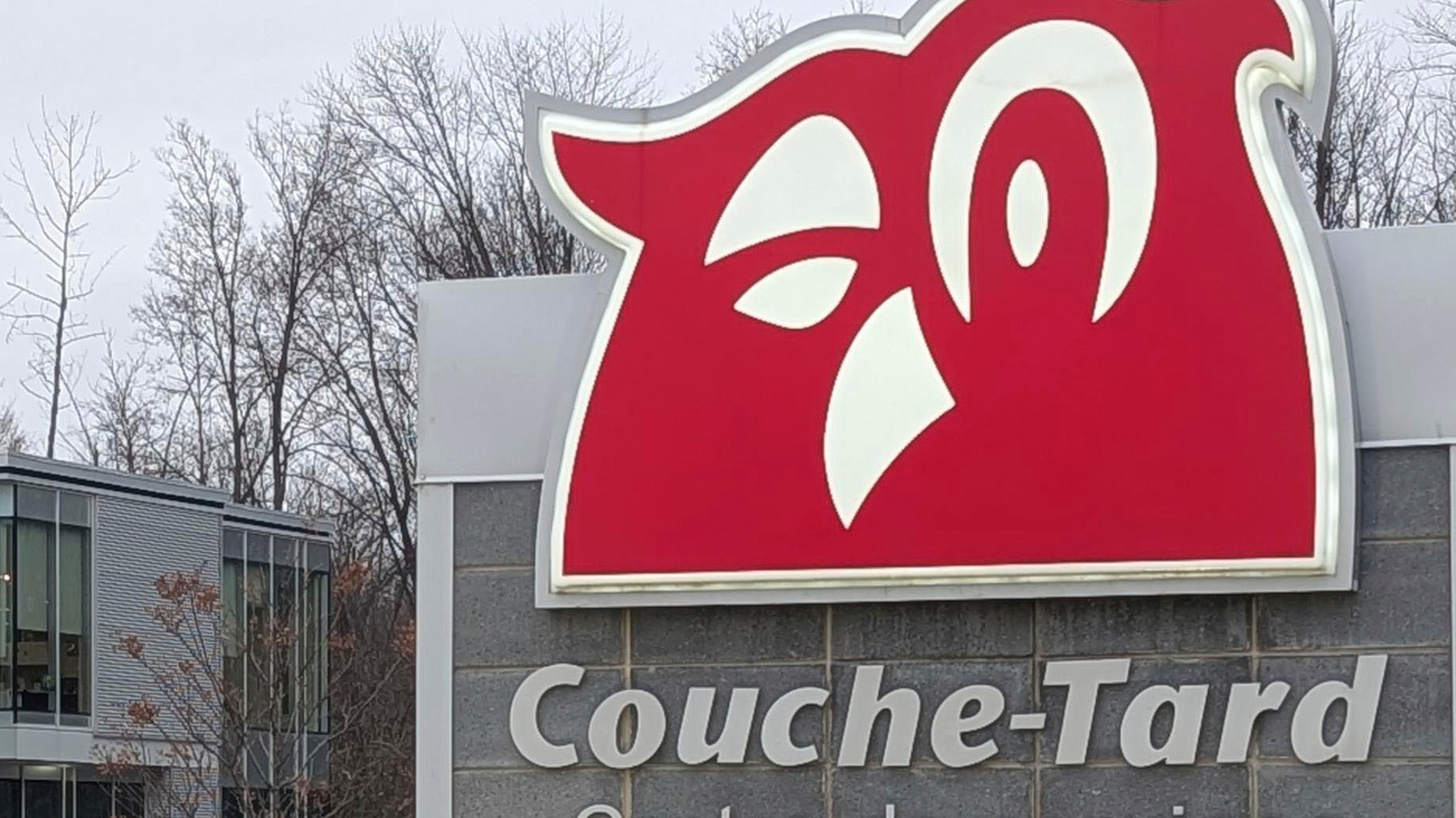 The logo of Canadian retail chain Alimentation Couche-Tard is seen at its headquarters in Laval, a suburb of Montreal, on Nov. 21, 2024. (Kyodo News via AP)
