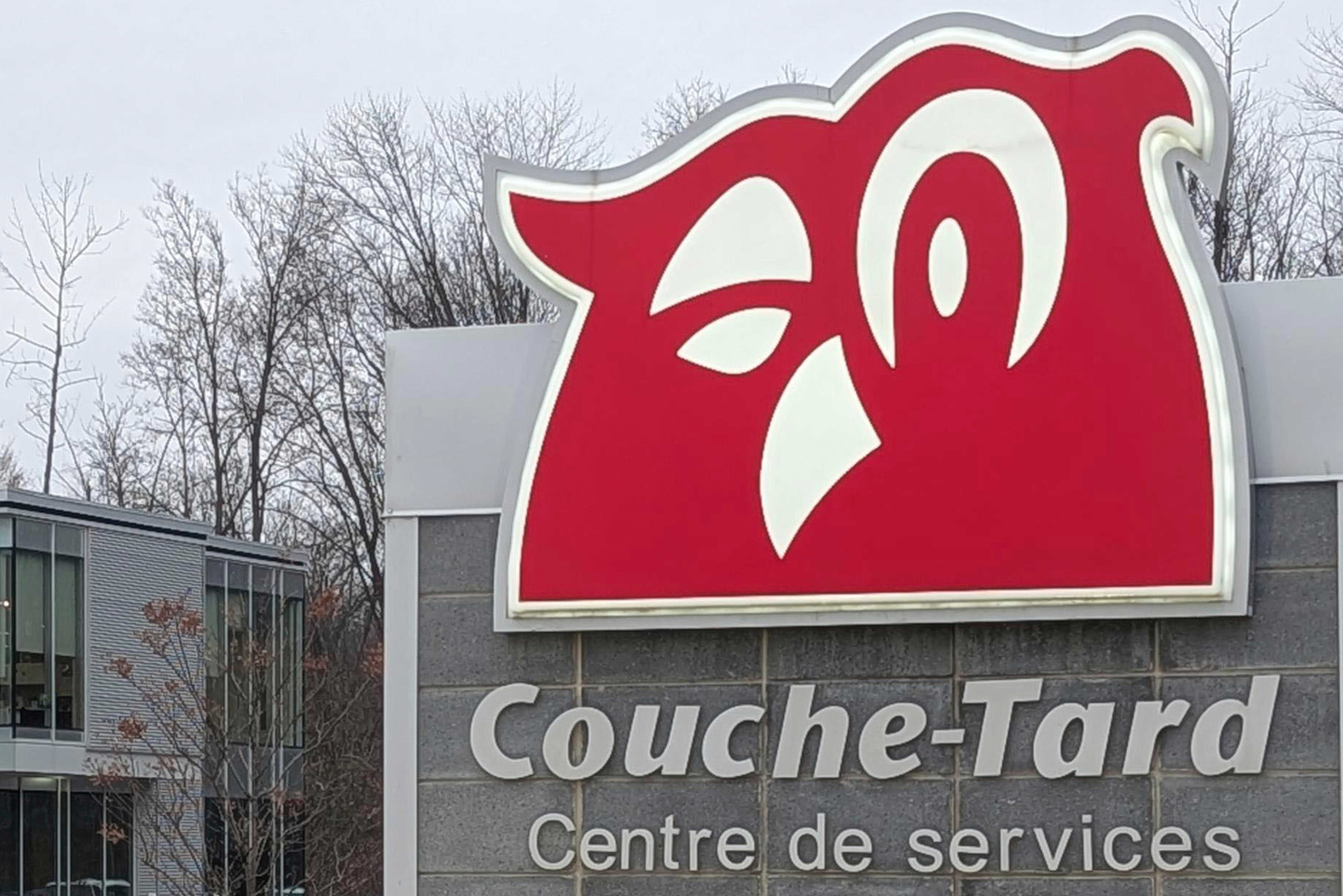 The logo of Canadian retail chain Alimentation Couche-Tard is seen at its headquarters in Laval, a suburb of Montreal, on Nov. 21, 2024. (Kyodo News via AP)