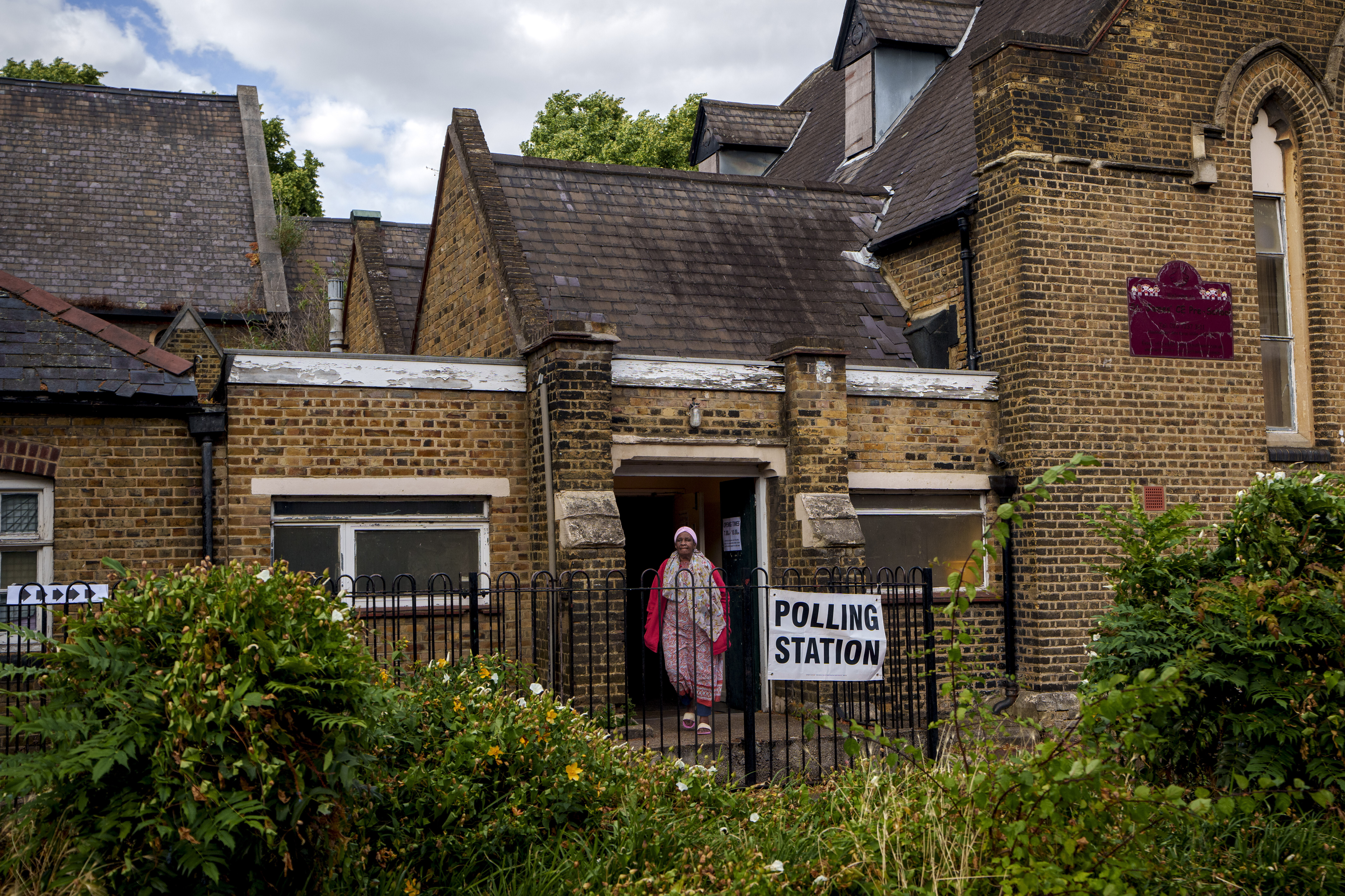 FILE - A woman exits a polling station set up at St. Anne's Church, Bermondsey, in London, on July 4, 2024. (AP Photo/Vadim Ghirda, File)