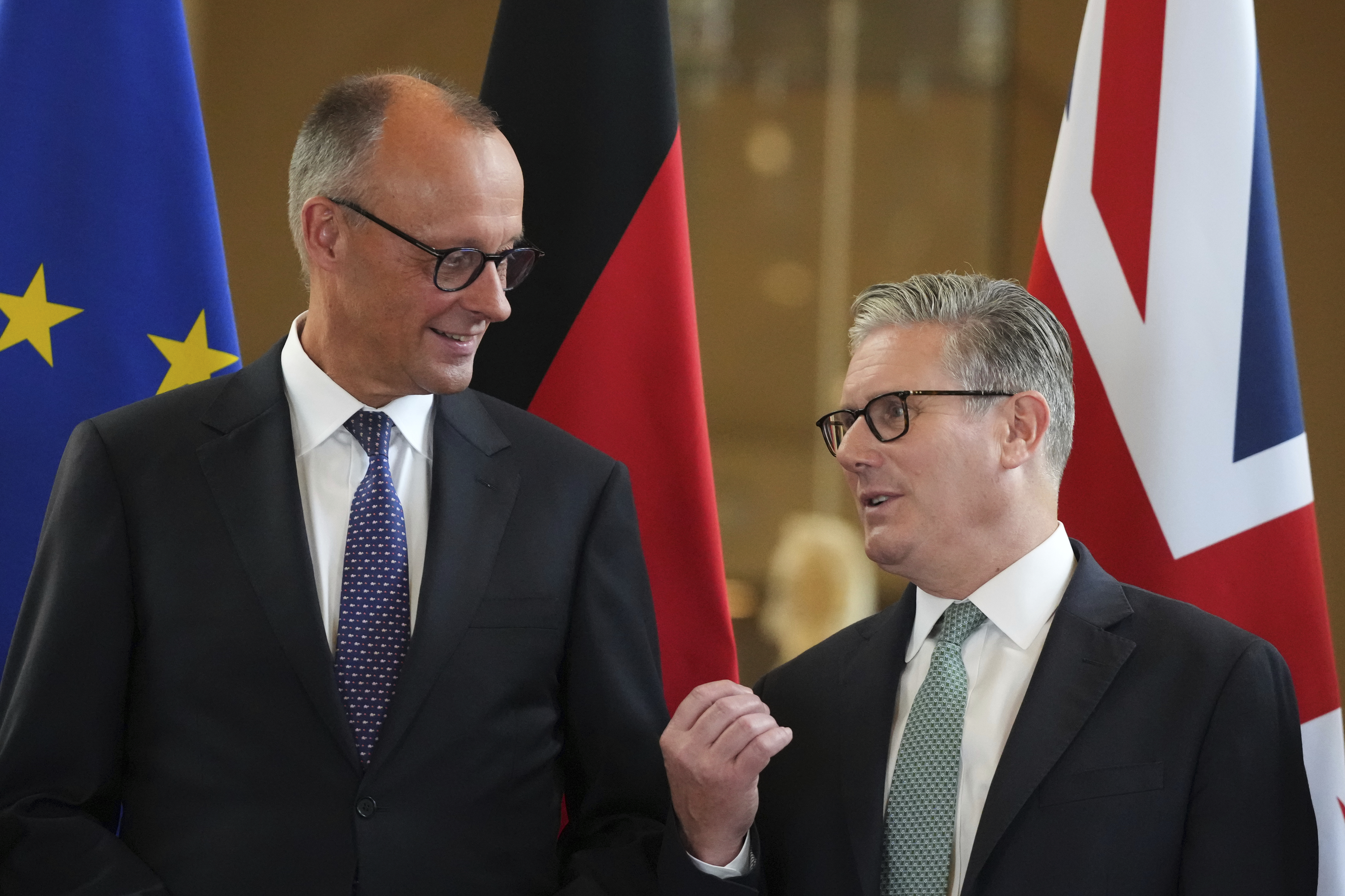 Britain's Prime Minister Keir Starmer, right, and German Chancellor Friedrich Merz, left, talk as they attend a signing ceremony of a wide-ranging bilateral cooperation treaty in London, Thursday, July 17, 2025.(AP Photo/Frank Augstein, Pool)
