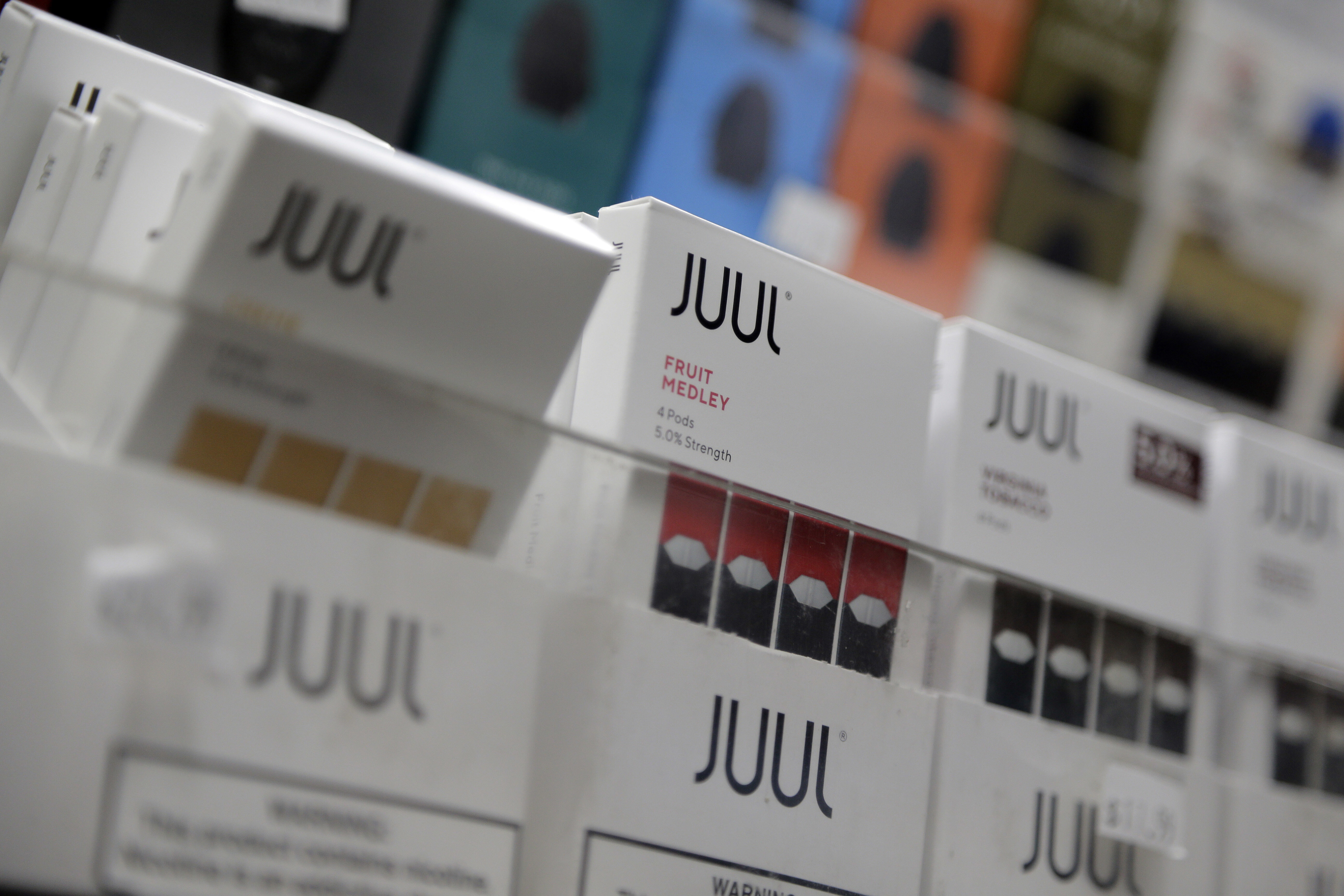 FILE - Juul products are displayed at a smoke shop in New York, on Dec. 20, 2018. (AP Photo/Seth Wenig, File)