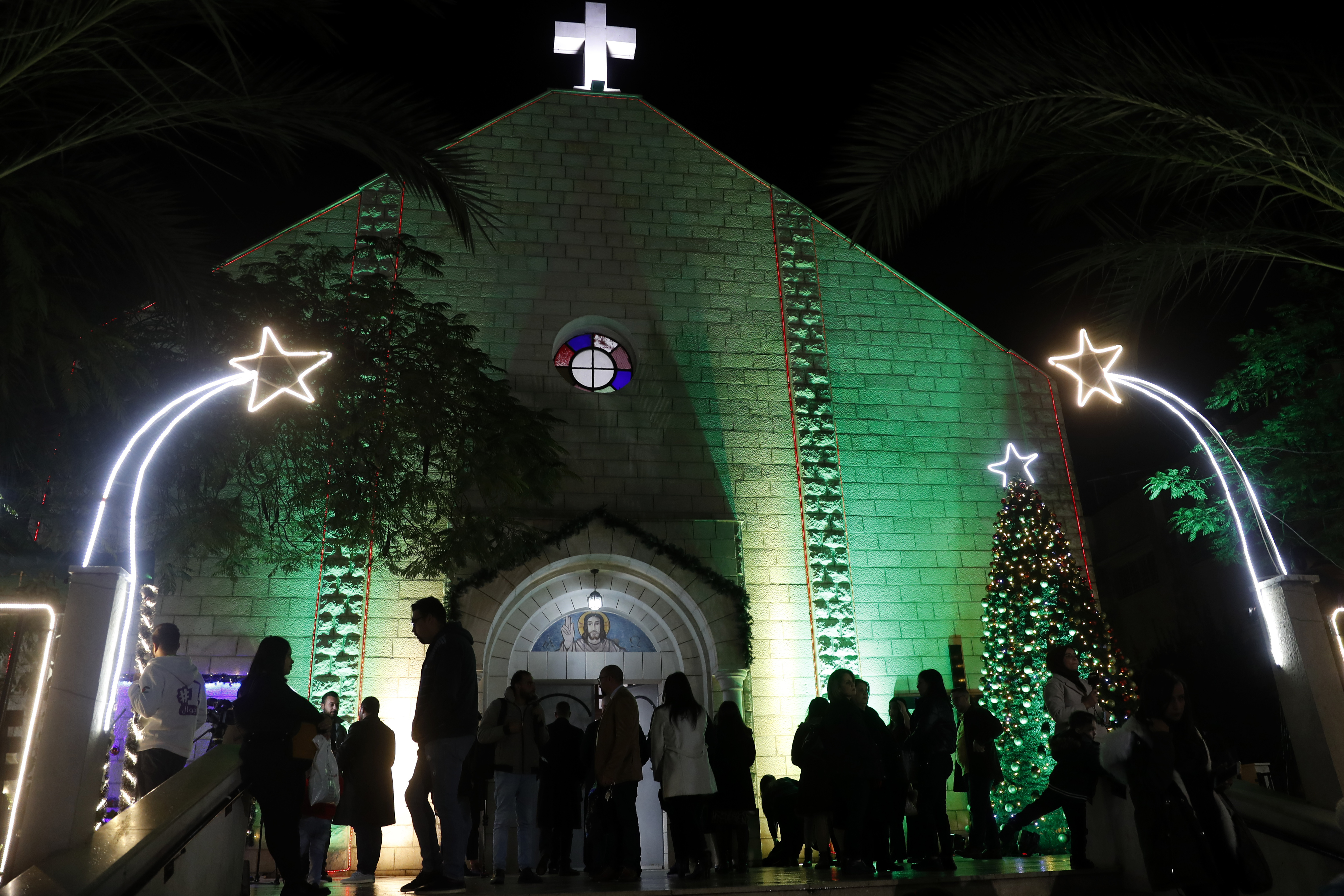 FILE - Palestinian Christians wait to pray at the midnight Christmas Eve mass out side the Deir Al Latin Holy Family Catholic Church in Gaza City, Dec. 24, 2021. (AP Photo/Adel Hana, file)