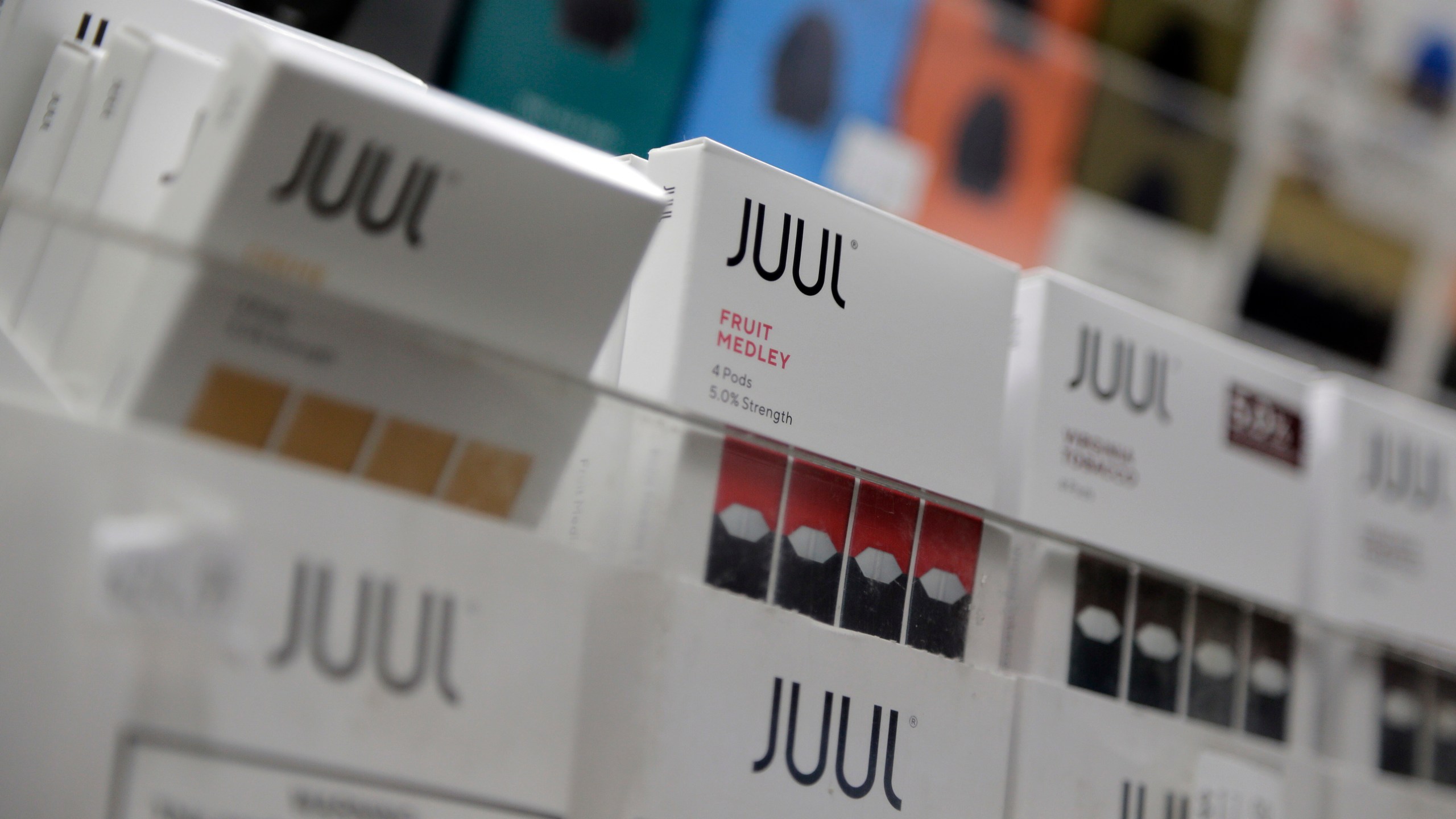 FILE - Juul products are displayed at a smoke shop in New York, on Dec. 20, 2018. (AP Photo/Seth Wenig, File)