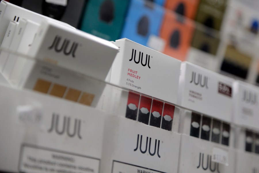 FILE - Juul products are displayed at a smoke shop in New York, on Dec. 20, 2018. (AP Photo/Seth Wenig, File)