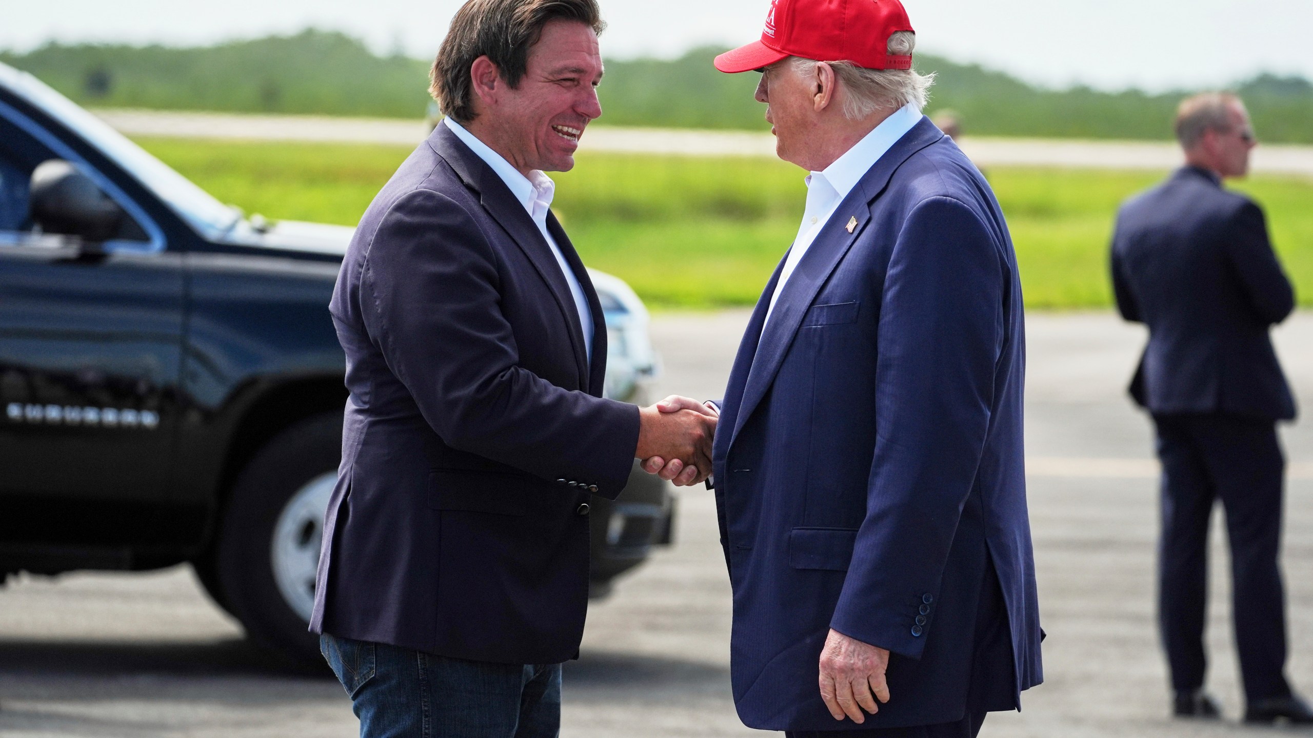 President Donald Trump is greeted by Gov. Ron DeSantis, R-Fla., as he arrives at "Alligator Alcatraz," a new migrant detention facility at Dade-Collier Training and Transition facility, Tuesday, July 1, 2025, in Ochopee, Fla. (AP Photo/Evan Vucci)