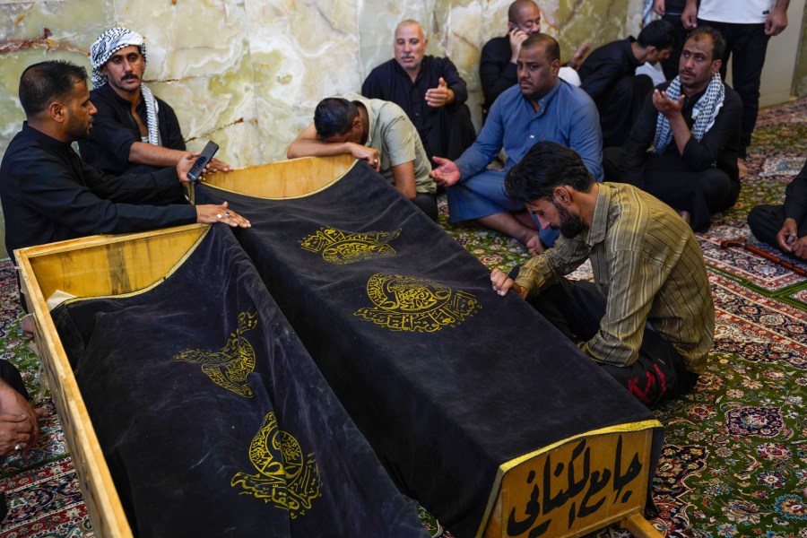 Mourners attend the funeral of victims who died in a fire at a shopping center in Kut, at the shrine of Imam Ali in Najaf, Iraq, Thursday, July 17, 2025. (AP Photo/Anmar Khalil)