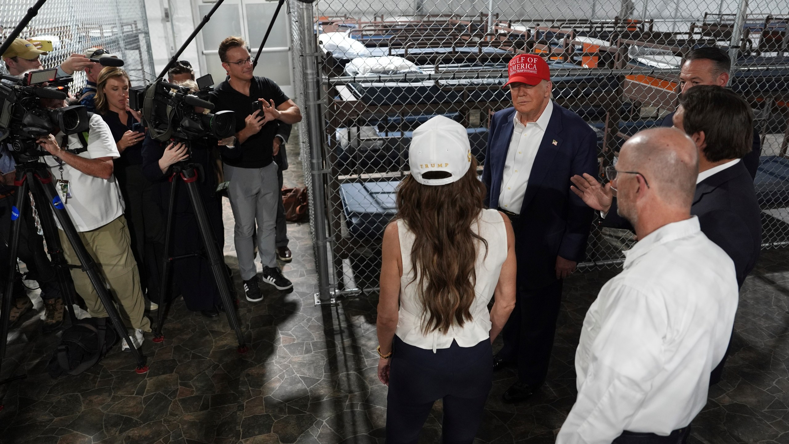 President Donald Trump, Gov. Ron DeSantis, R-Fla., and Homeland Security Secretary Kristi Noem, and others, tour "Alligator Alcatraz," a new migrant detention facility at Dade-Collier Training and Transition facility, Tuesday, July 1, 2025, in Ochopee, Fla. (AP Photo/Evan Vucci)