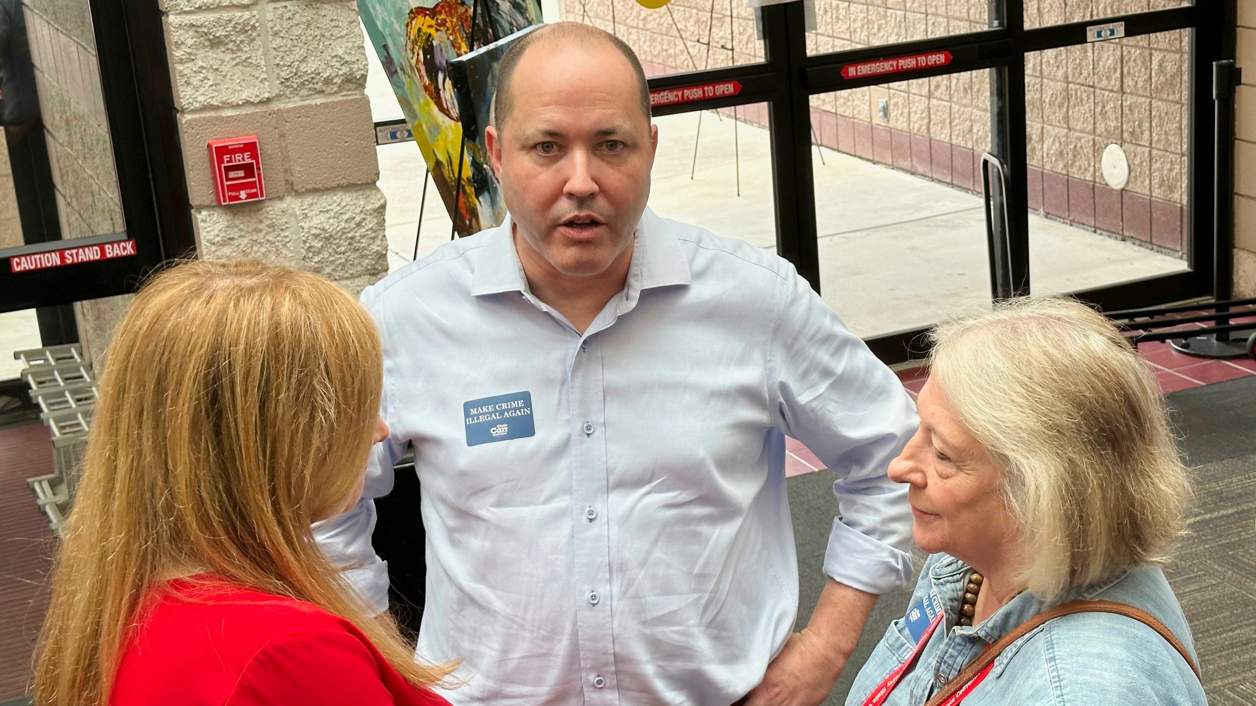 FILE - Georgia Attorney General Chris Carr, center, speaks to a delegate at the Georgia Republican Convention in Dalton, Ga., Friday, June 6, 2025. (AP Photo/Jeff Amy, File)