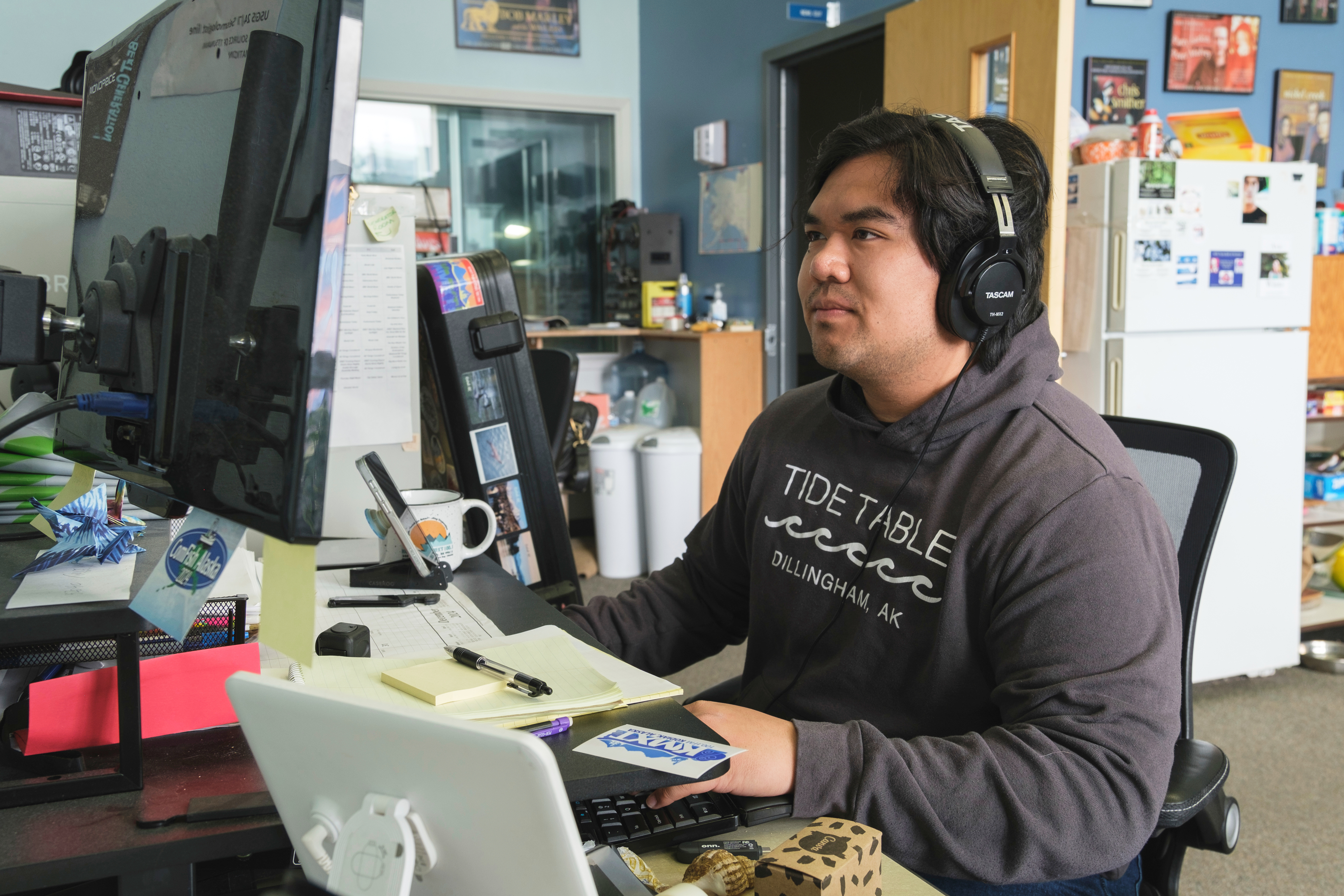 This photo provided by Brian Venua shows Venua, a reporter at the public radio station KMXT, on air, Thursday, July 17, 2025, in Kodiak, Alaska. (Brian Venua via AP)