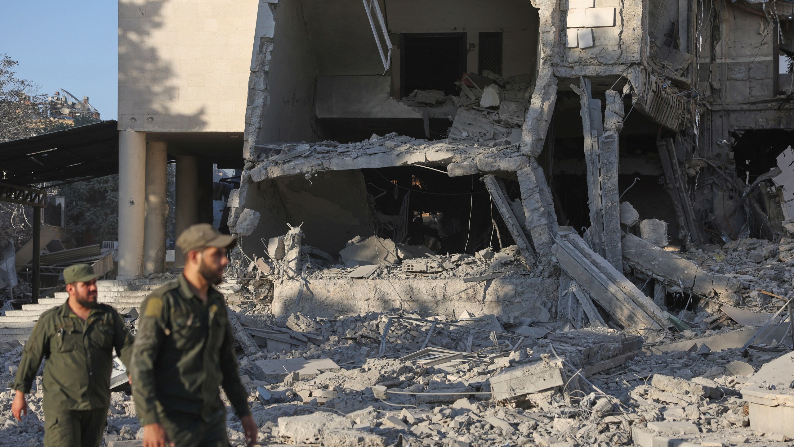 Soldiers inspect the damaged Syrian Defense Ministry building allegedly hit by several Israeli airstrikes, in Damascus, Syria, Wednesday, July 16, 2025. (AP Photo/Ghaith Alsayed)