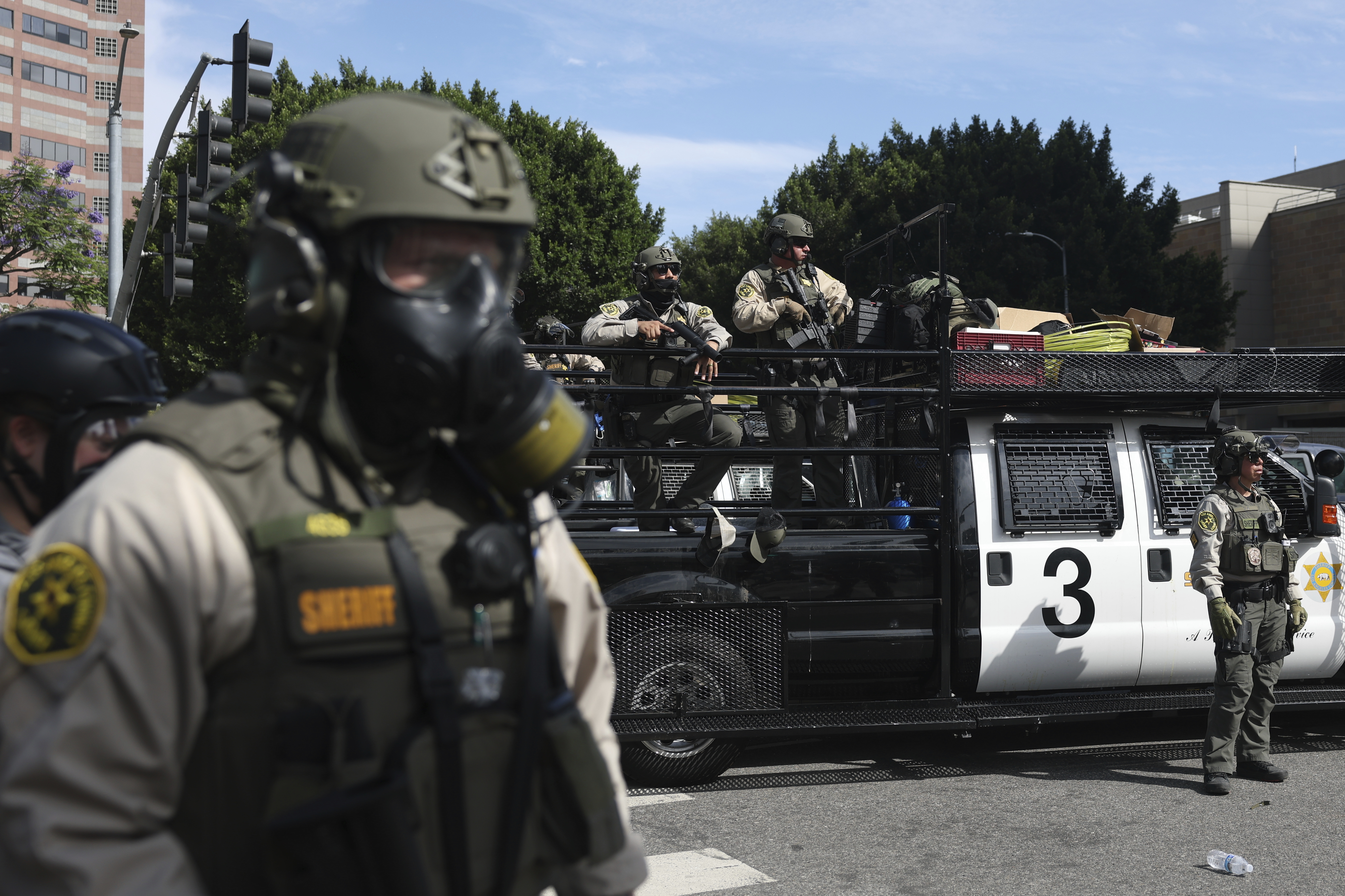 FILE - Law enforcement officers stand guard during a protest June 14, 2025, in Los Angeles. (AP Photo/Ethan Swope, File)