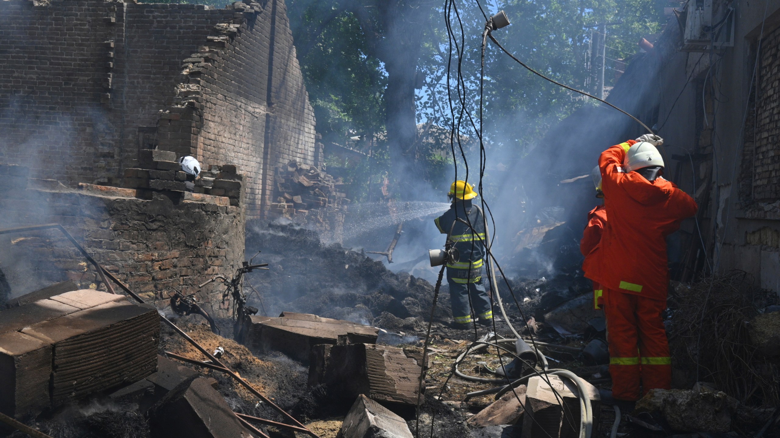 Emergency services personnel work to extinguish a fire following a Russian attack in Odesa, Ukraine, Friday, July 11, 2025. (AP Photo/Michael Shtekel)