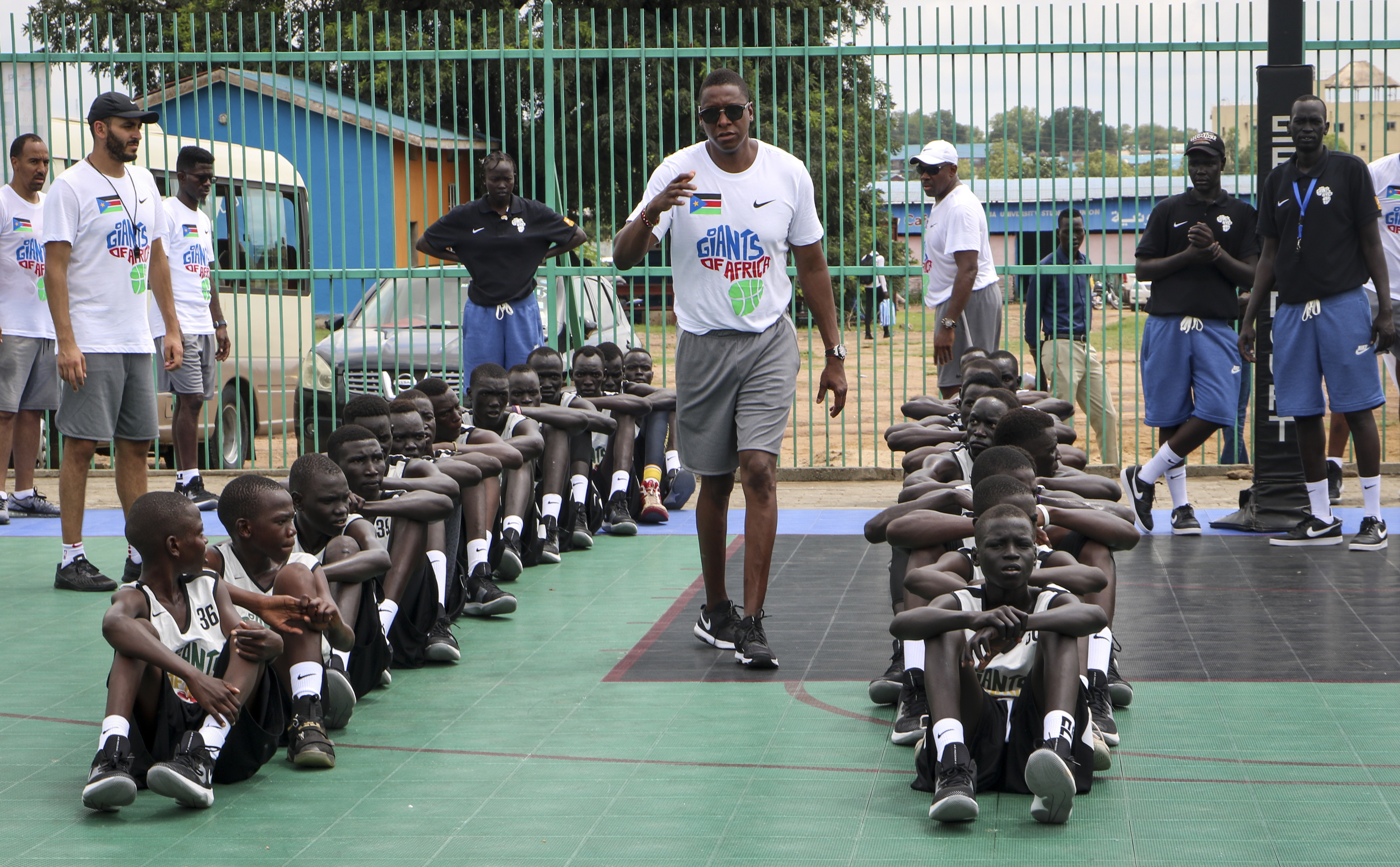 FILE - Masai Ujiri walks between rows of youth players on the basketball court during a three-day basketball training camp run by Giants of Africa in Juba, South Sudan, Aug. 20, 2019. (AP Photo/Sam Mednick, File)