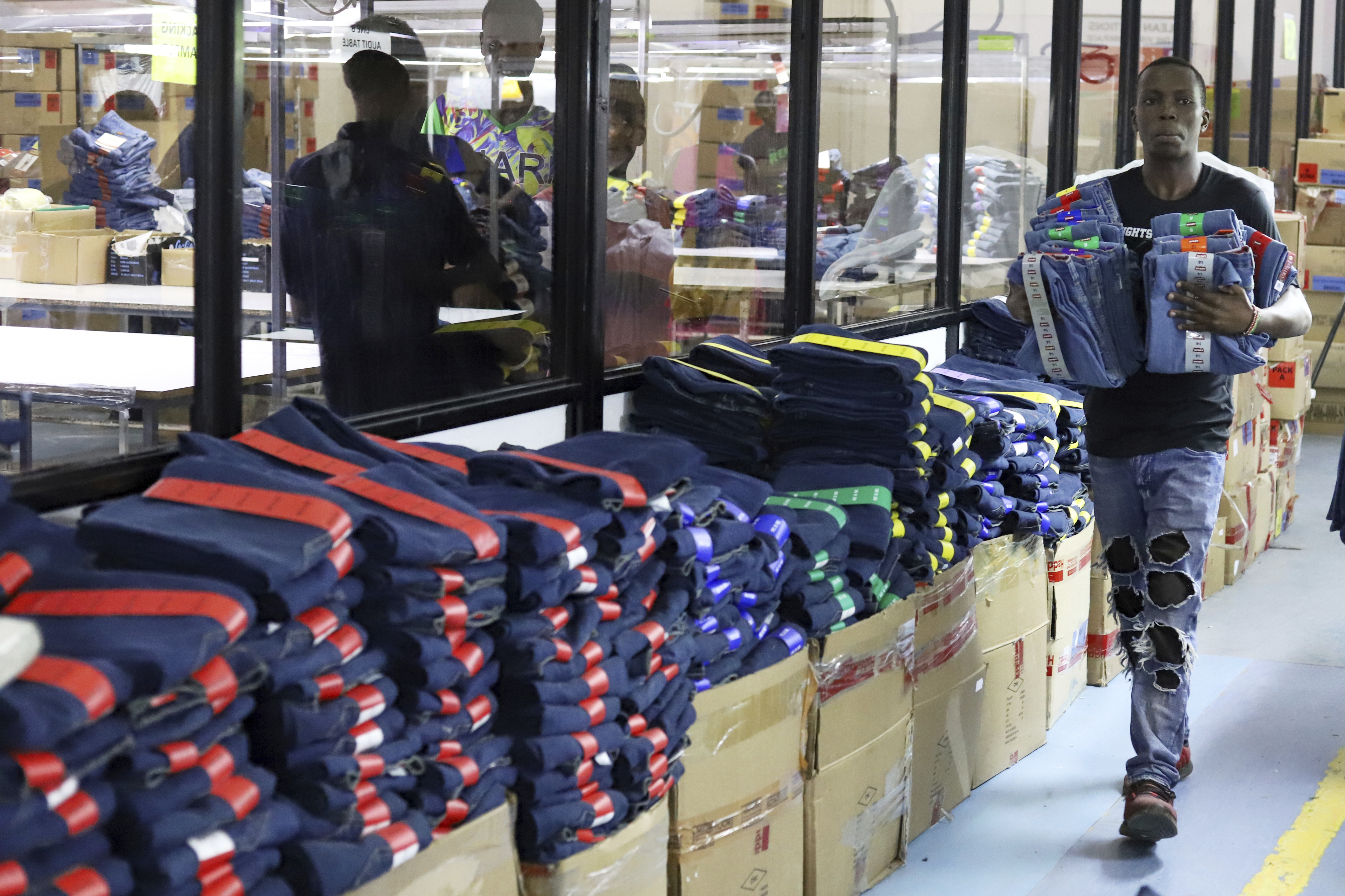 FILE -A factory worker arranges garments at United Aryan EPZ Limited in Ruaraka on the outskirts of Nairobi, Kenya, March 21, 2025. (AP Photo/Andrew Kasuku, File)