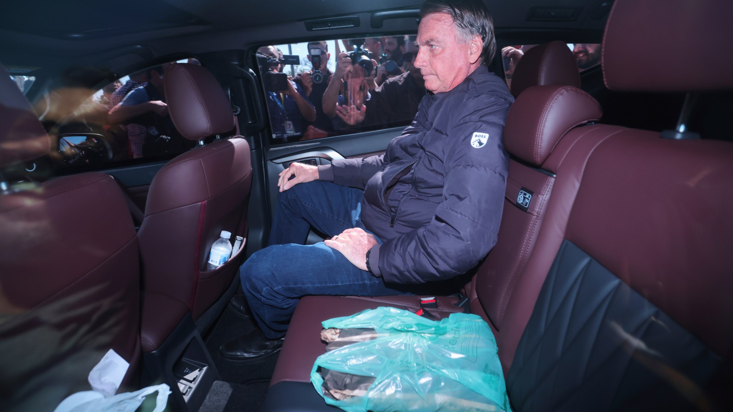 Brazil's former President Jair Bolsonaro leaves the Secretariat of Penitentiary Administration where he arrived after the Supreme Court ordered him to be fitted with an electronic ankle monitor in Brasilia, Brazil, Friday, July 18, 2025. (AP Photo/Luis Nova)