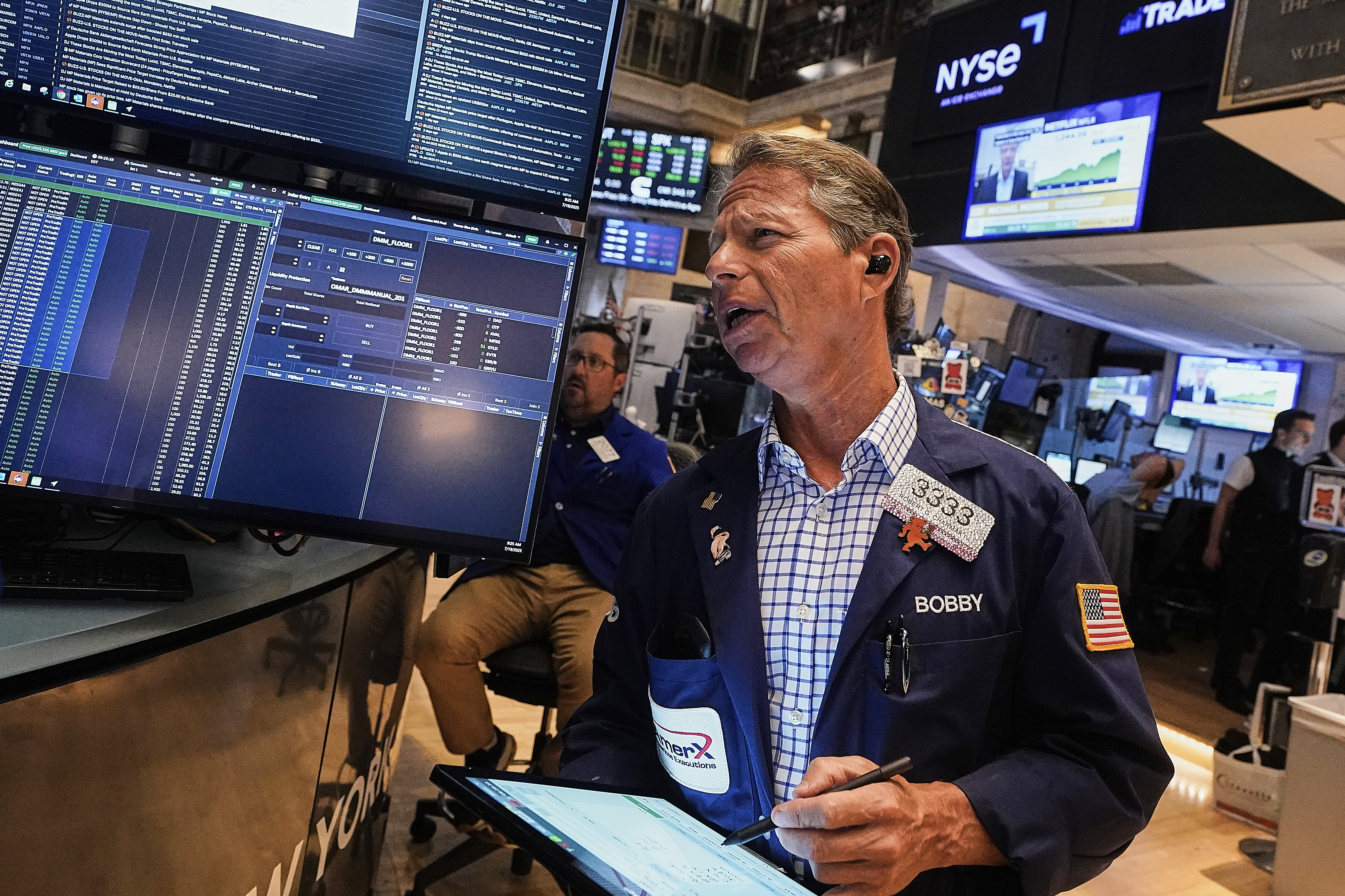 Trader Robert Charmak works on the floor of the New York Stock Exchange, Friday, July 18, 2025. (AP Photo/Richard Drew)