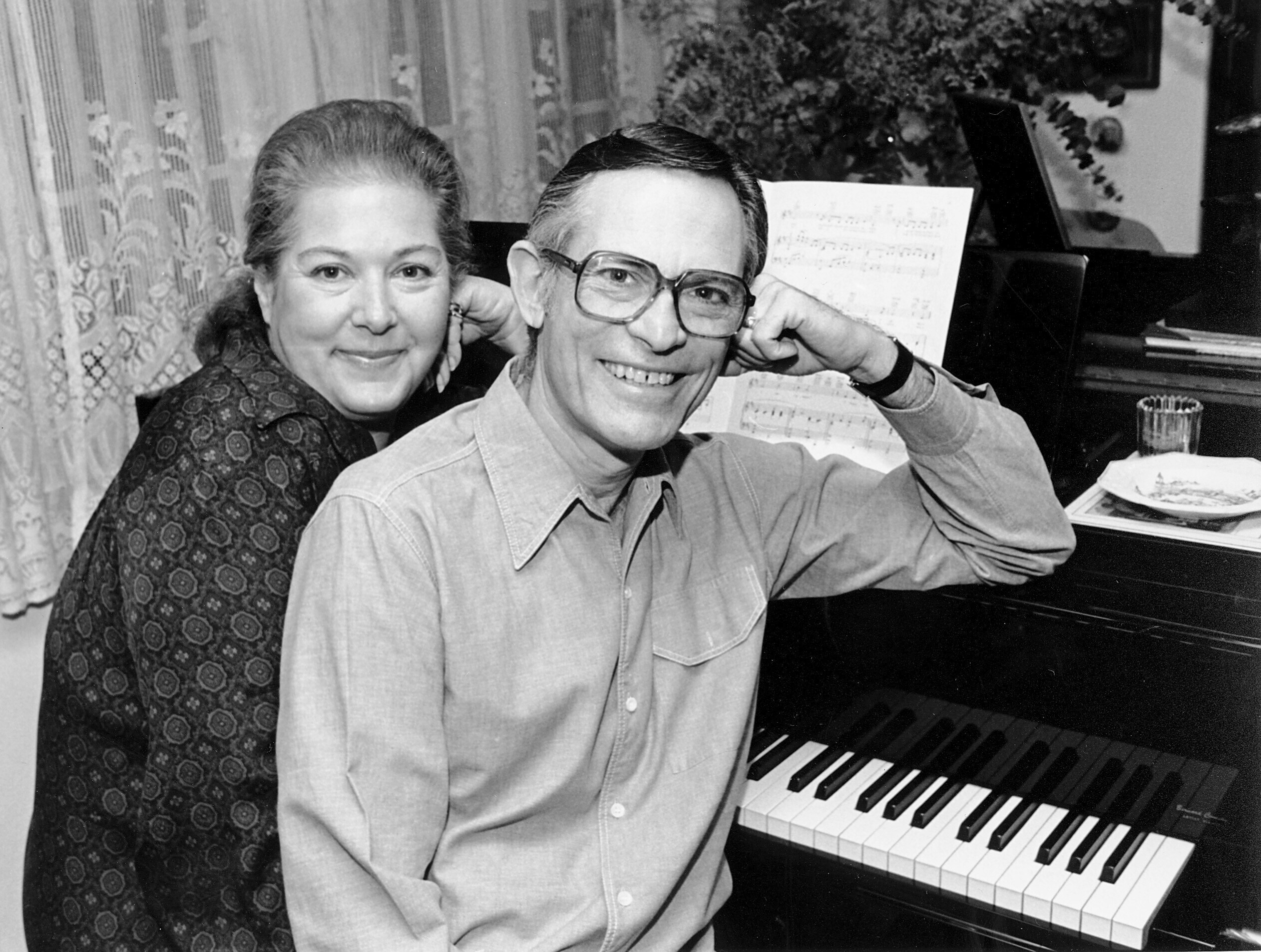 FILE - Marilyn and Alan Bergman pose at their piano in their Beverly Hills home on March 17, 1980. (AP Photo/Lennox McLendon, File)