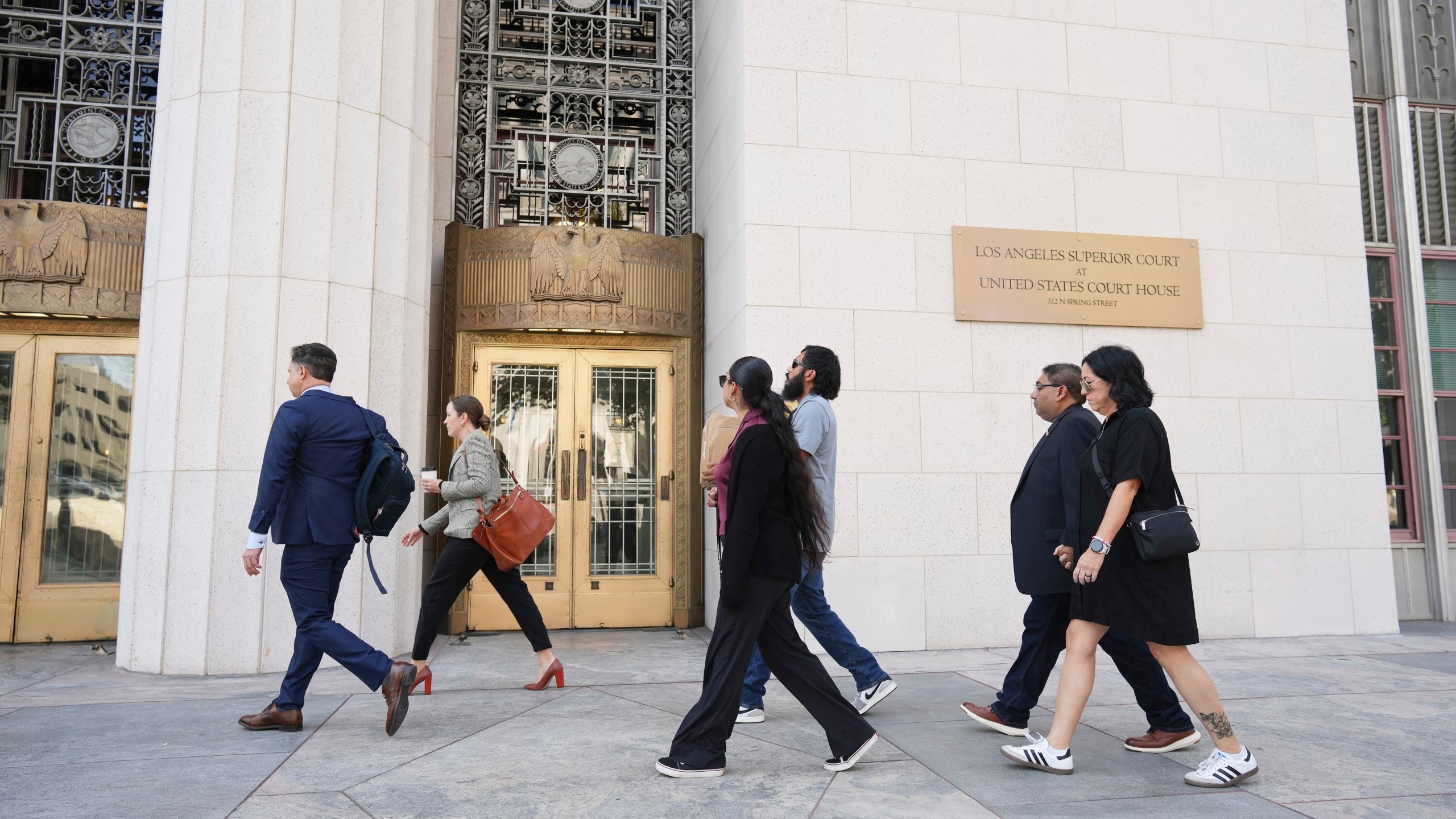 Plantiffs and their lawyers arrive for a court hearing in a lawsuit between victims' families in the 2022 Uvalde, Texas school shooting and Meta Platforms on Friday, July 18, 2025, in Los Angeles. (AP Photo/Eric Thayer)