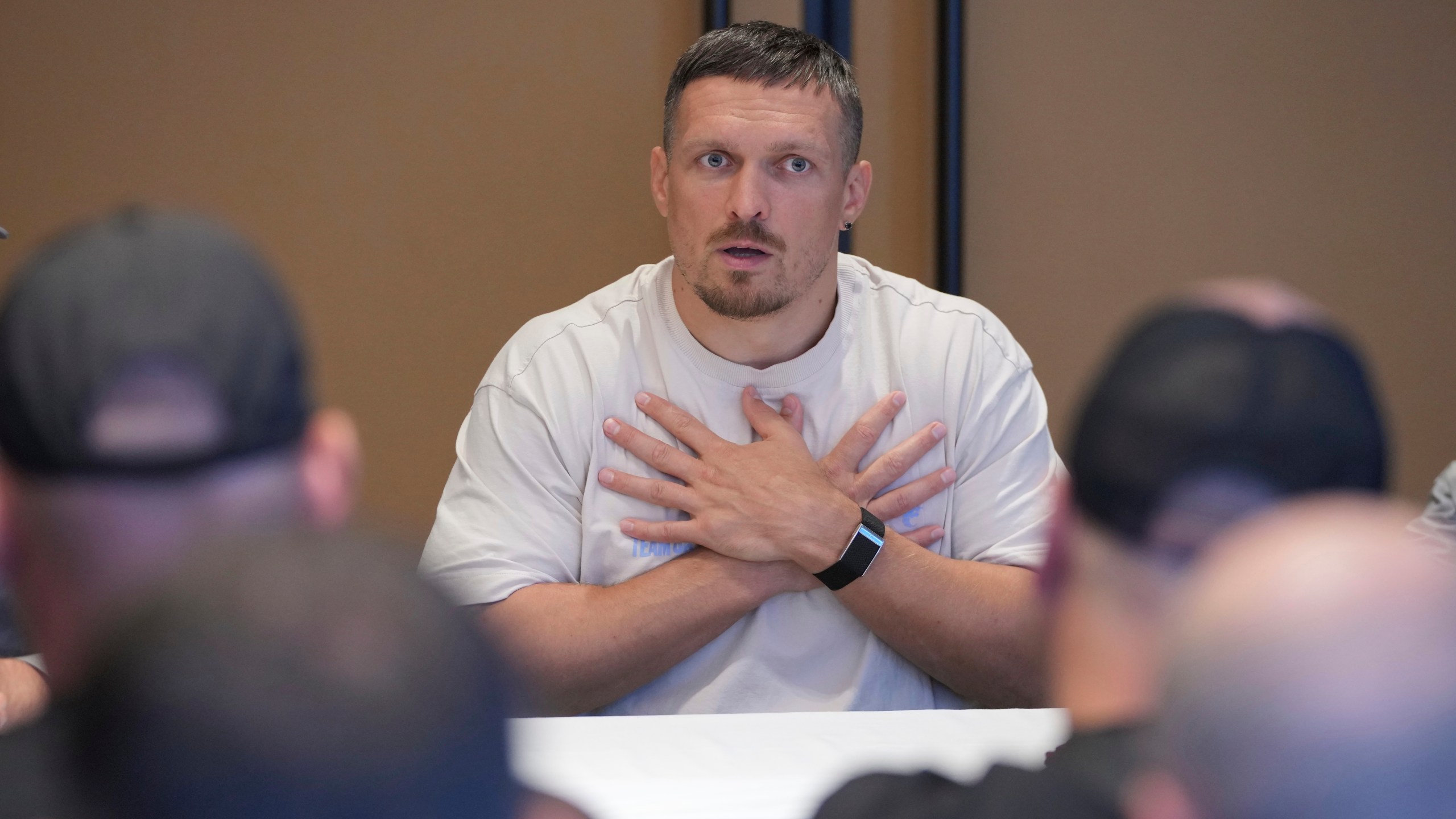 Ukraine's boxer Oleksandr Usyk speaks as he meets the Ukrainian war veterans, who are employees of Ukrainian power company DTEK at a hotel in Battersea Park in London, Thursday, July 17, 2025 ahead of the undisputed heavyweight champion boxing fight between Britain's Daniel Dubois and Oleksandr Usyk on Saturday. (AP Photo/Kin Cheung)