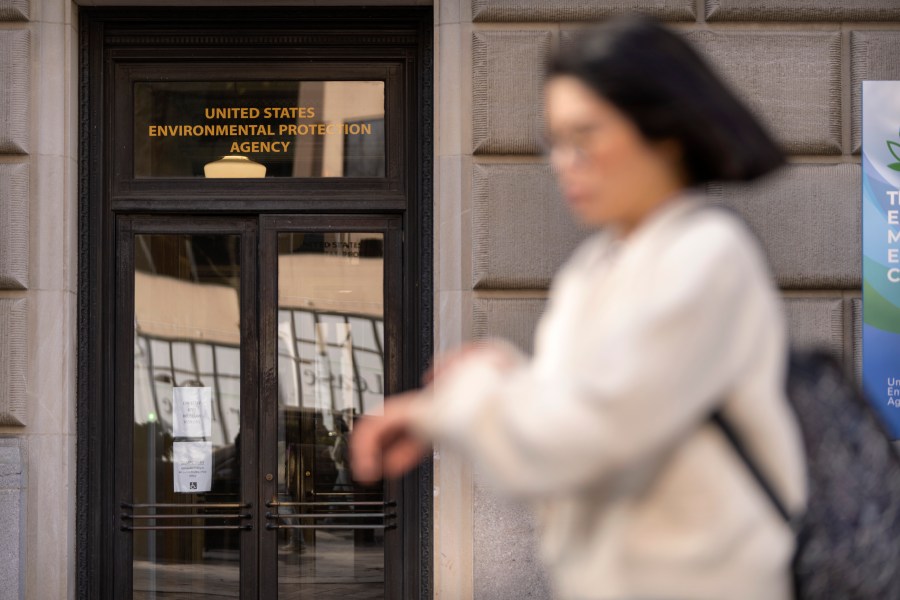 FILE - A person walks past the headquarters building of the Environmental Protection Agency, March 12, 2025, in Washington. (AP Photo/Mark Schiefelbein, File)