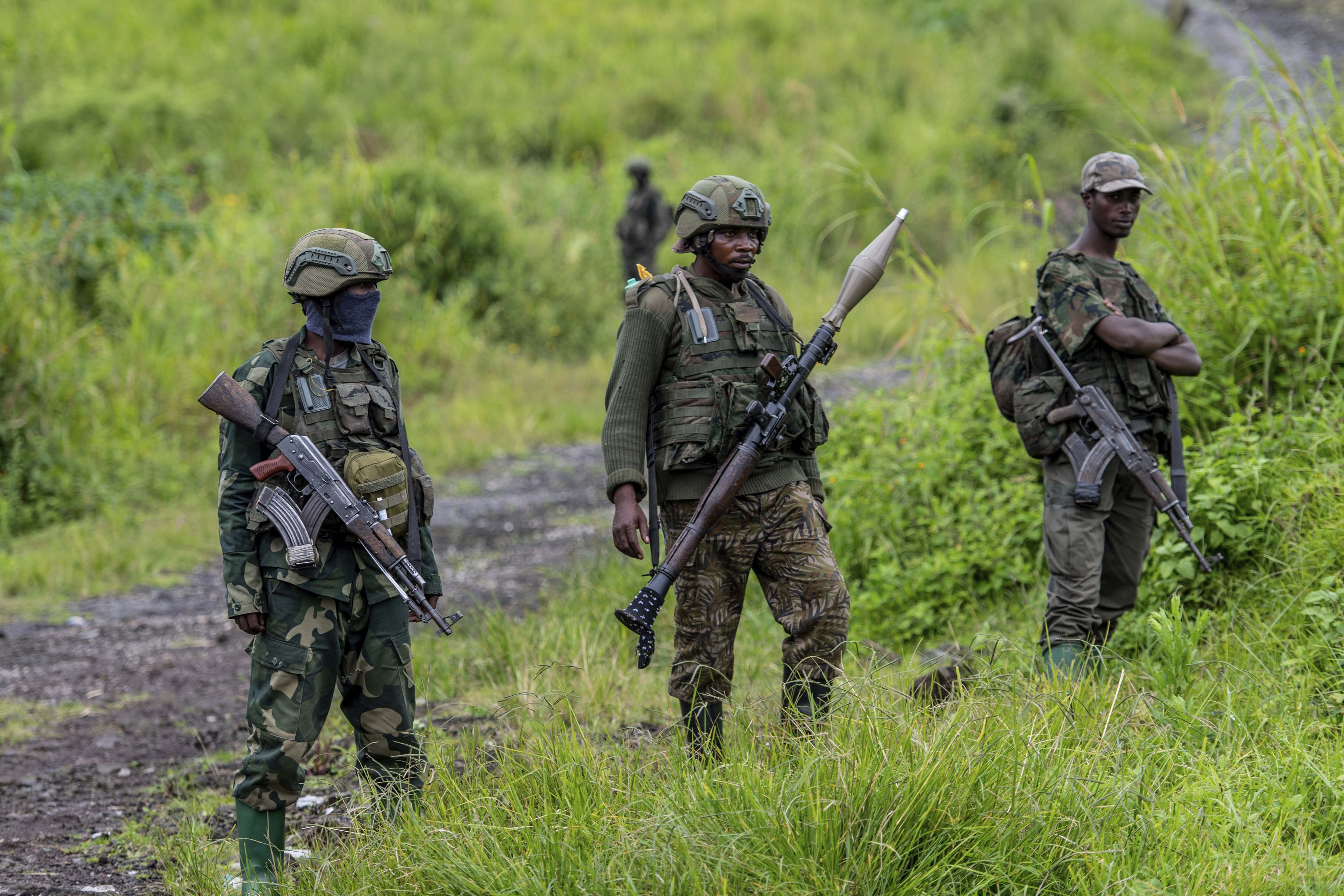 FILE - M23 rebels stand with their weapons in Kibumba, in the eastern of Democratic Republic of Congo, Dec. 23, 2022. (AP Photo/Moses Sawasawa, File)