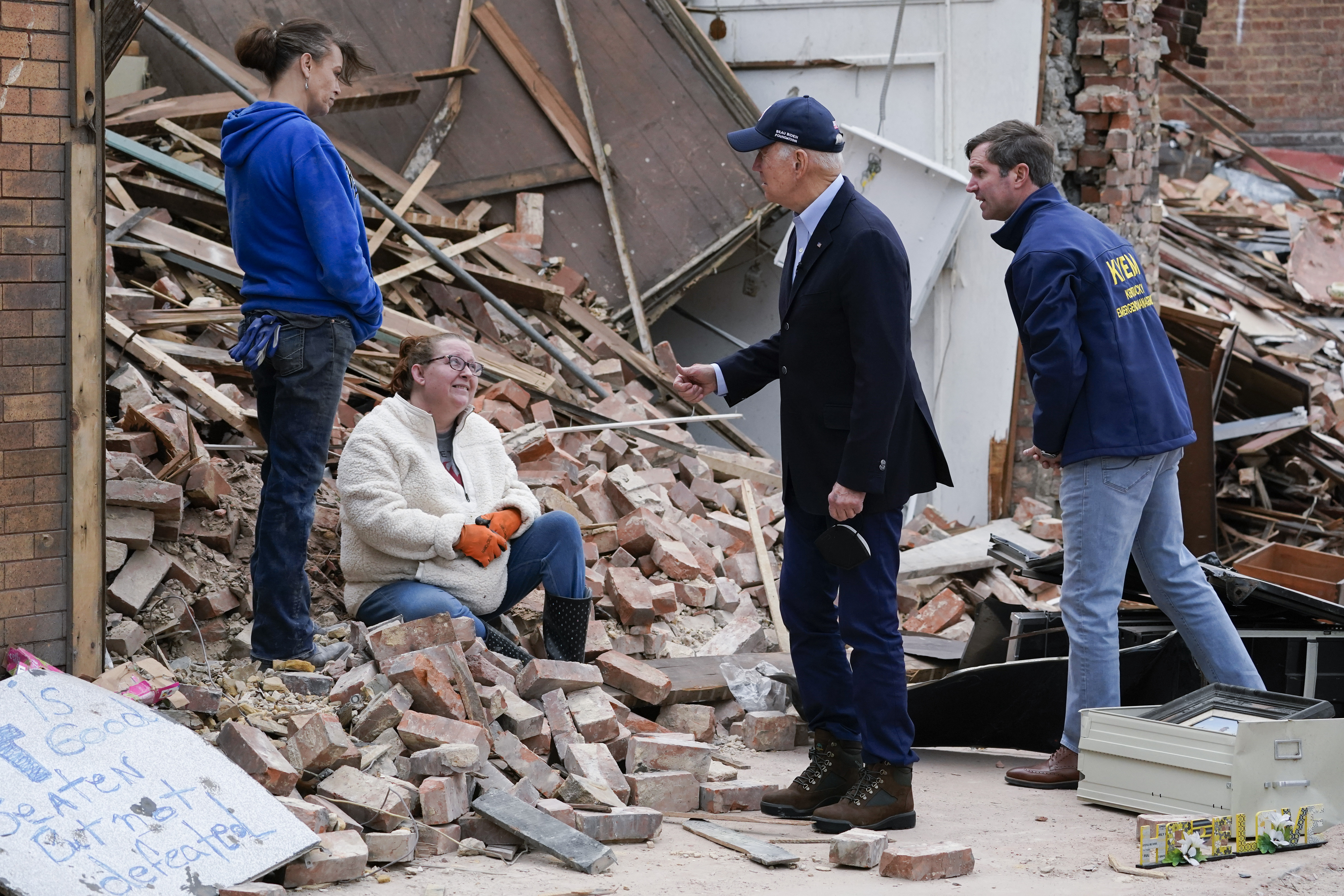 FILE - President Joe Biden, center right, and Kentucky Gov. Andy Beshear, right, talk to people as they survey storm damage from tornadoes and extreme weather in Mayfield, Ky., Dec. 15, 2021. (AP Photo/Andrew Harnik, File)