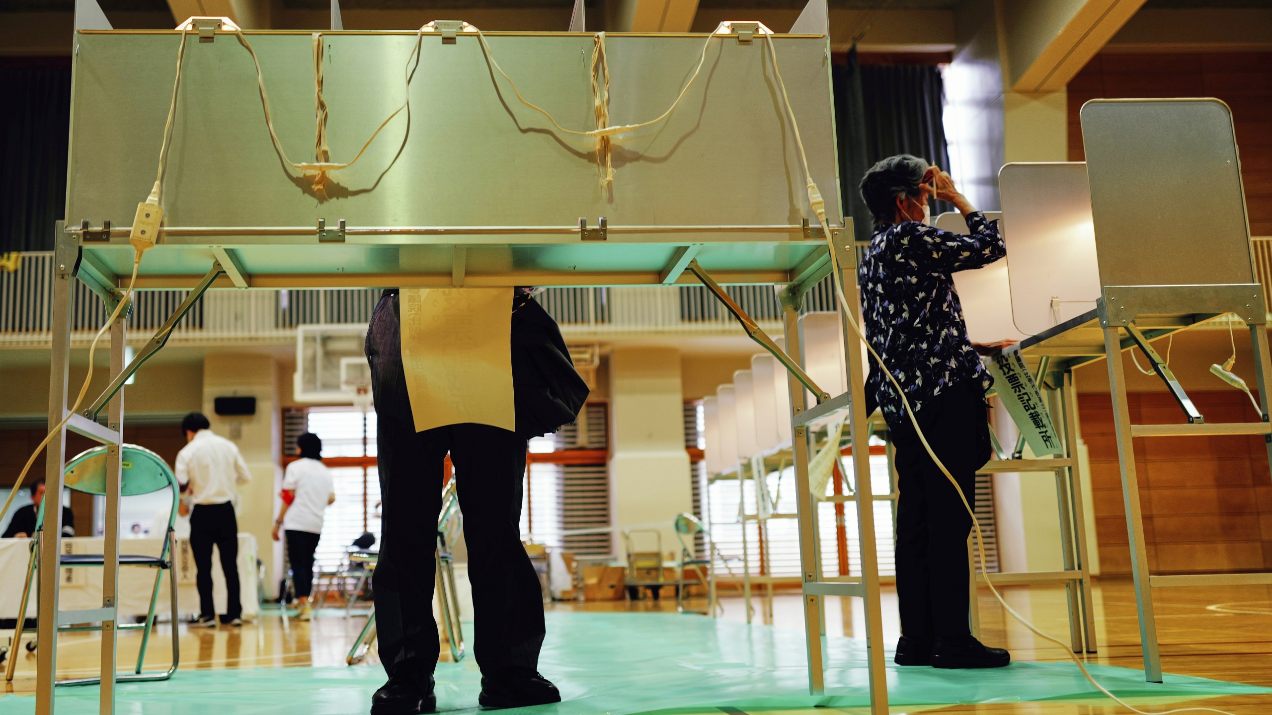 Voters fill in their ballots in the upper house election at a polling station Sunday, July 20, 2025, in Tokyo. (AP Photo/Eugene Hoshiko)