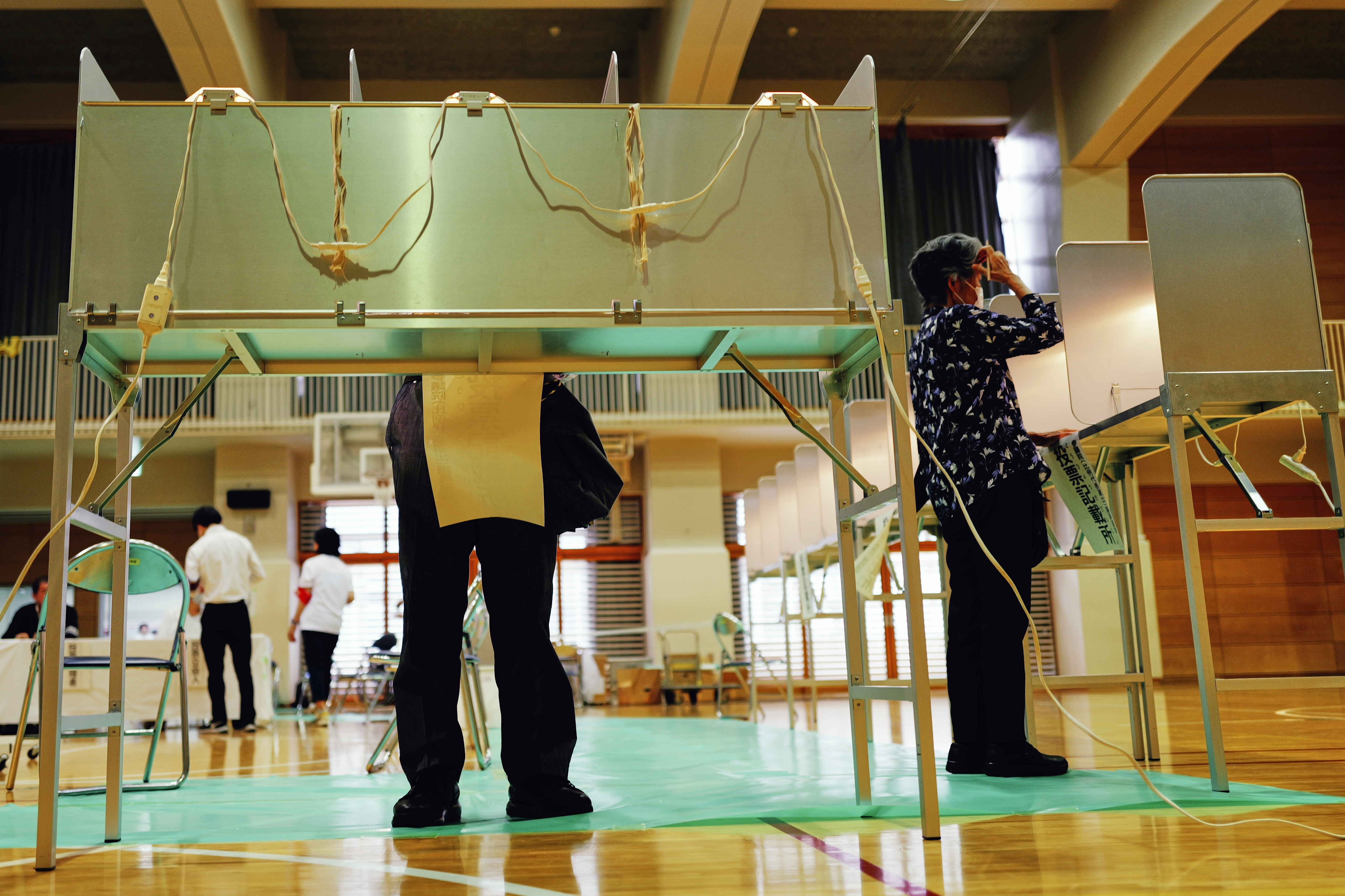 Voters fill in their ballots in the upper house election at a polling station Sunday, July 20, 2025, in Tokyo. (AP Photo/Eugene Hoshiko)