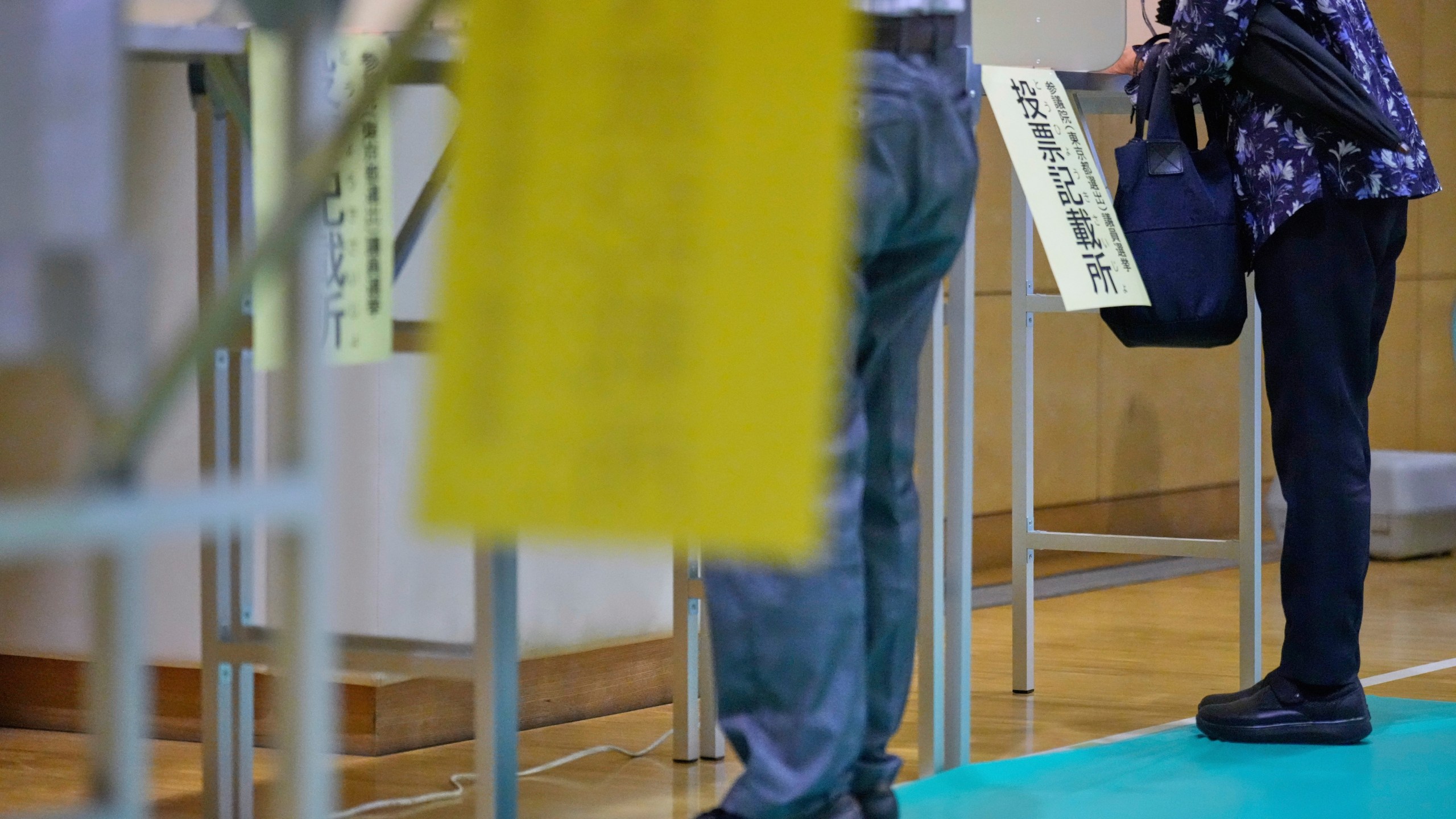Voters fill in their ballots in the upper house election at a polling station Sunday, July 20, 2025, in Tokyo. (AP Photo/Eugene Hoshiko)
