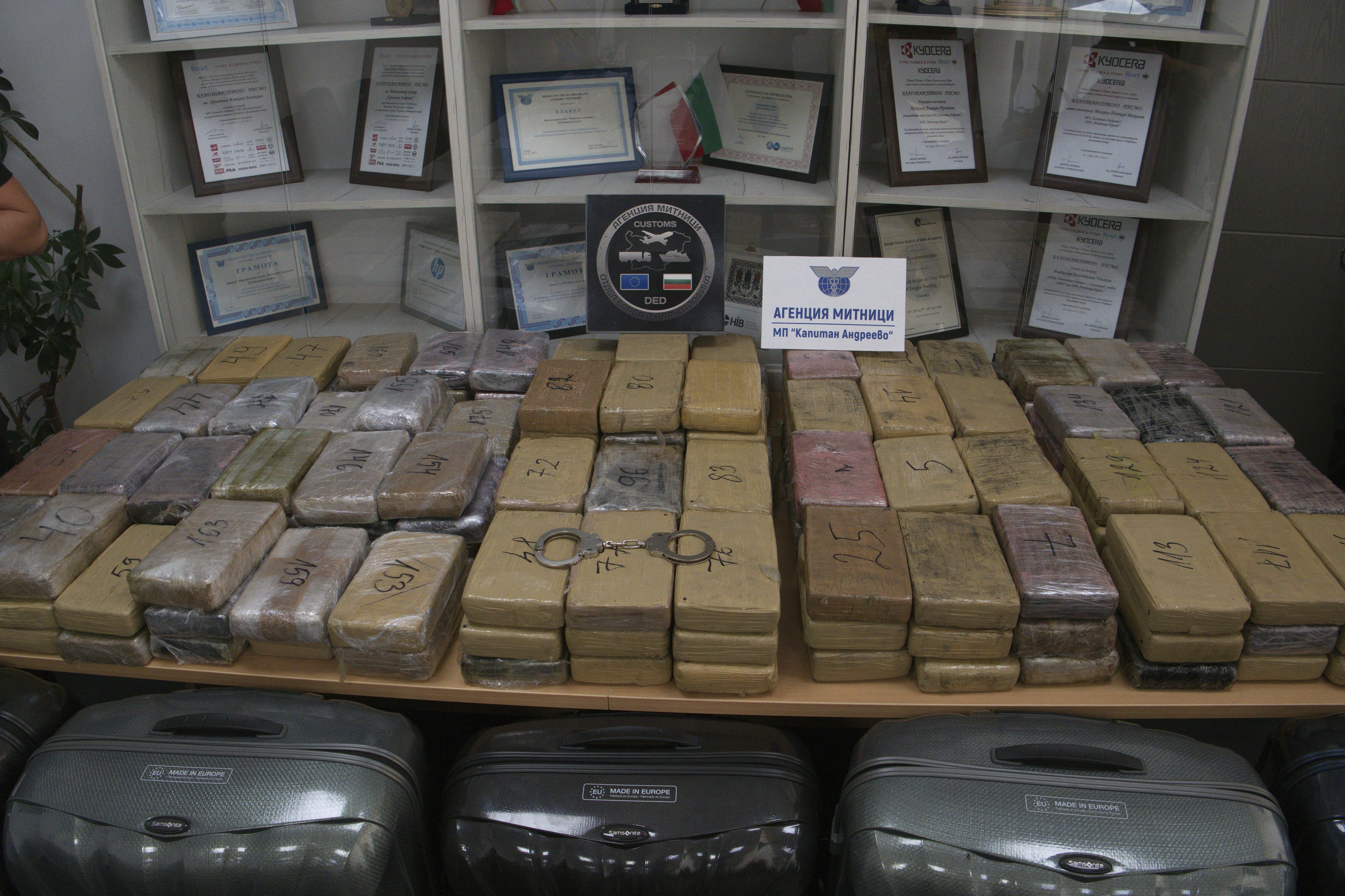 Sealed bags of cocaine which were hidden in suitcases, seen below, and seized by Bulgarian border authorities, are displayed at a border customs' office in Kapitan Andreevo, Bulgaria, Sunday, July 20, 2025. (Bulgarian Interior Ministry via AP)