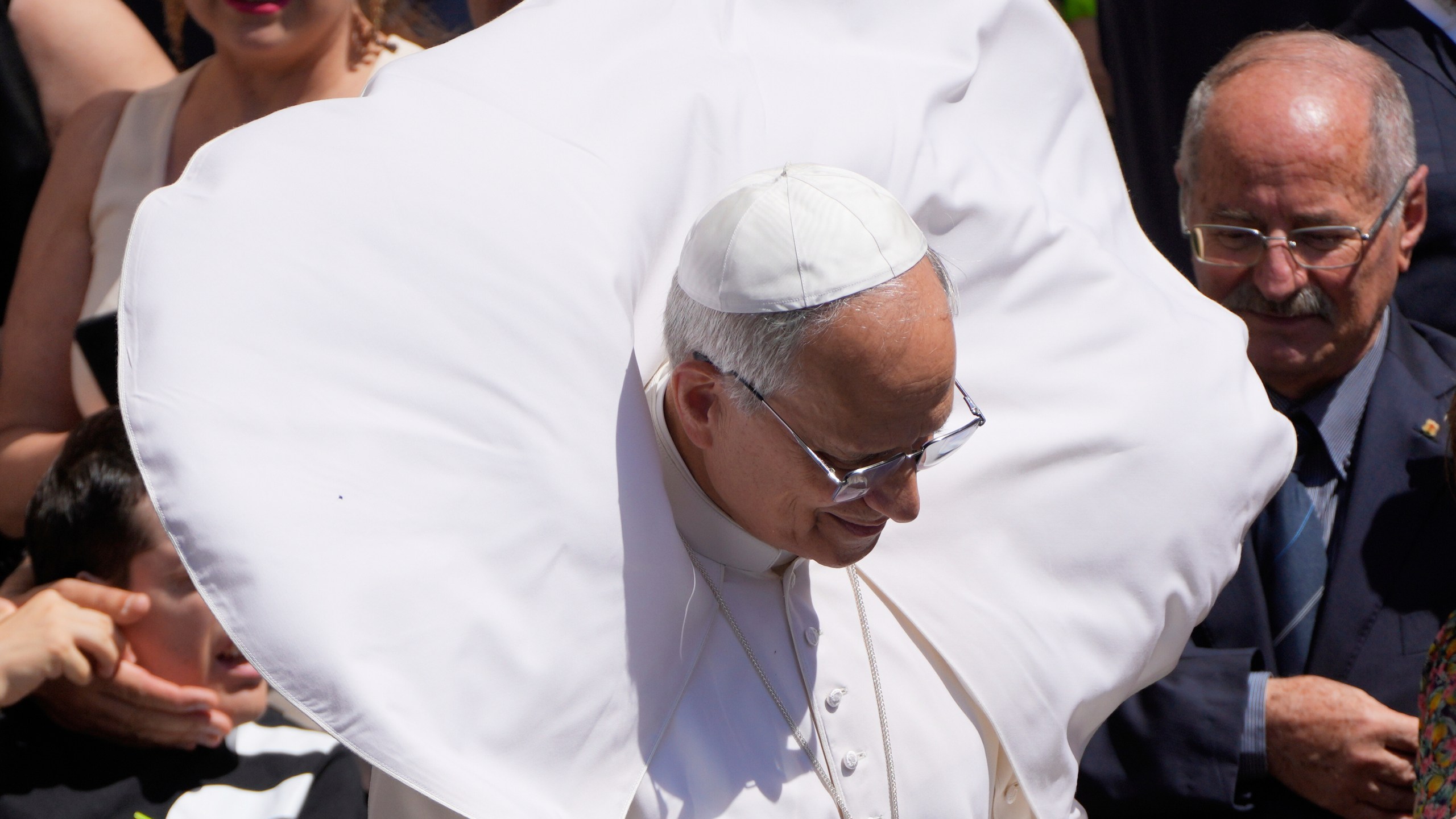 A gust of wind blows Pope Leo XIV's mantel at the end of the noon Angelus prayer in the square in front of the Apostolic Palace in Castel Gandolfo, Italy, Sunday, July 20, 2025. (AP Photo/Gregorio Borgia)