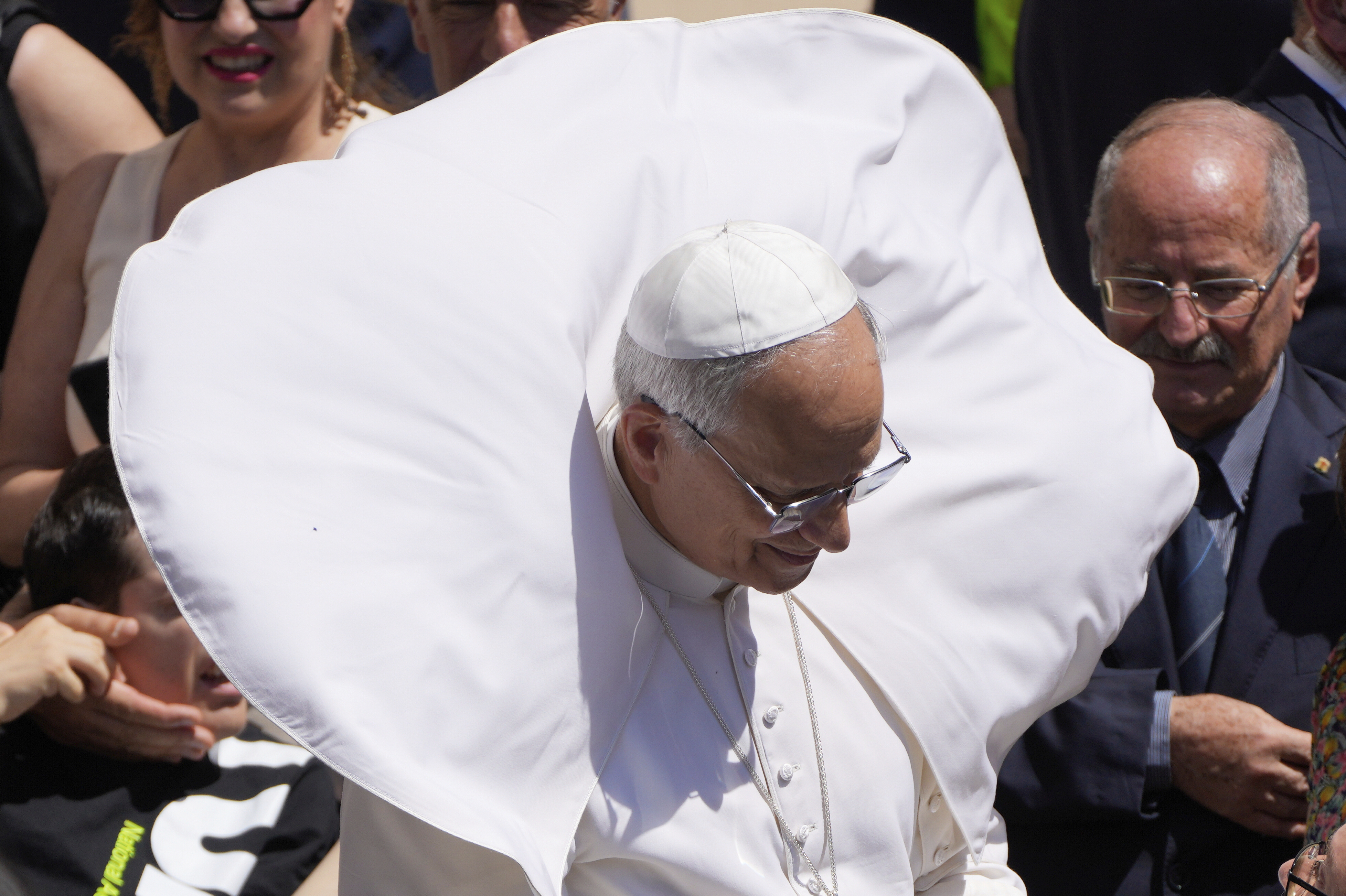 A gust of wind blows Pope Leo XIV's mantel at the end of the noon Angelus prayer in the square in front of the Apostolic Palace in Castel Gandolfo, Italy, Sunday, July 20, 2025. (AP Photo/Gregorio Borgia)