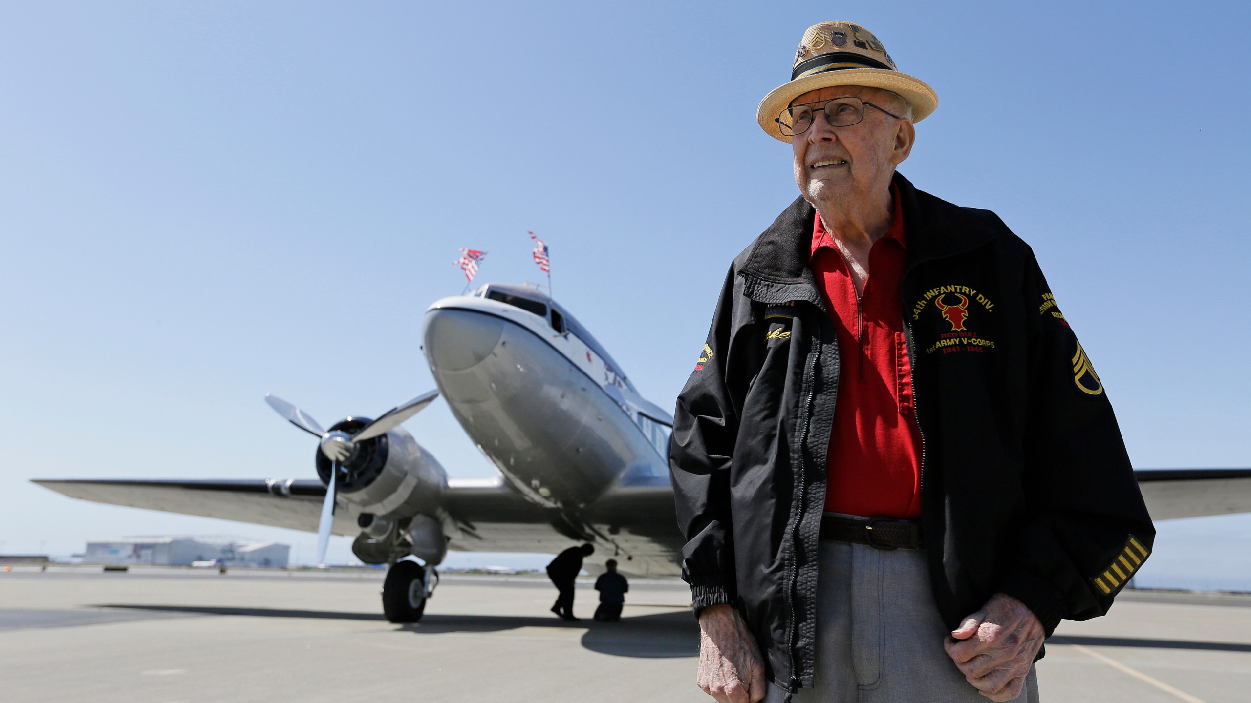 FILE - In this photo taken April 29, 2019, D-Day veteran Jake Larson poses before going for a ride in the "The Spirit of Benovia" World War II-era aircraft in Oakland, Calif. (AP Photo/Eric Risberg, file)
