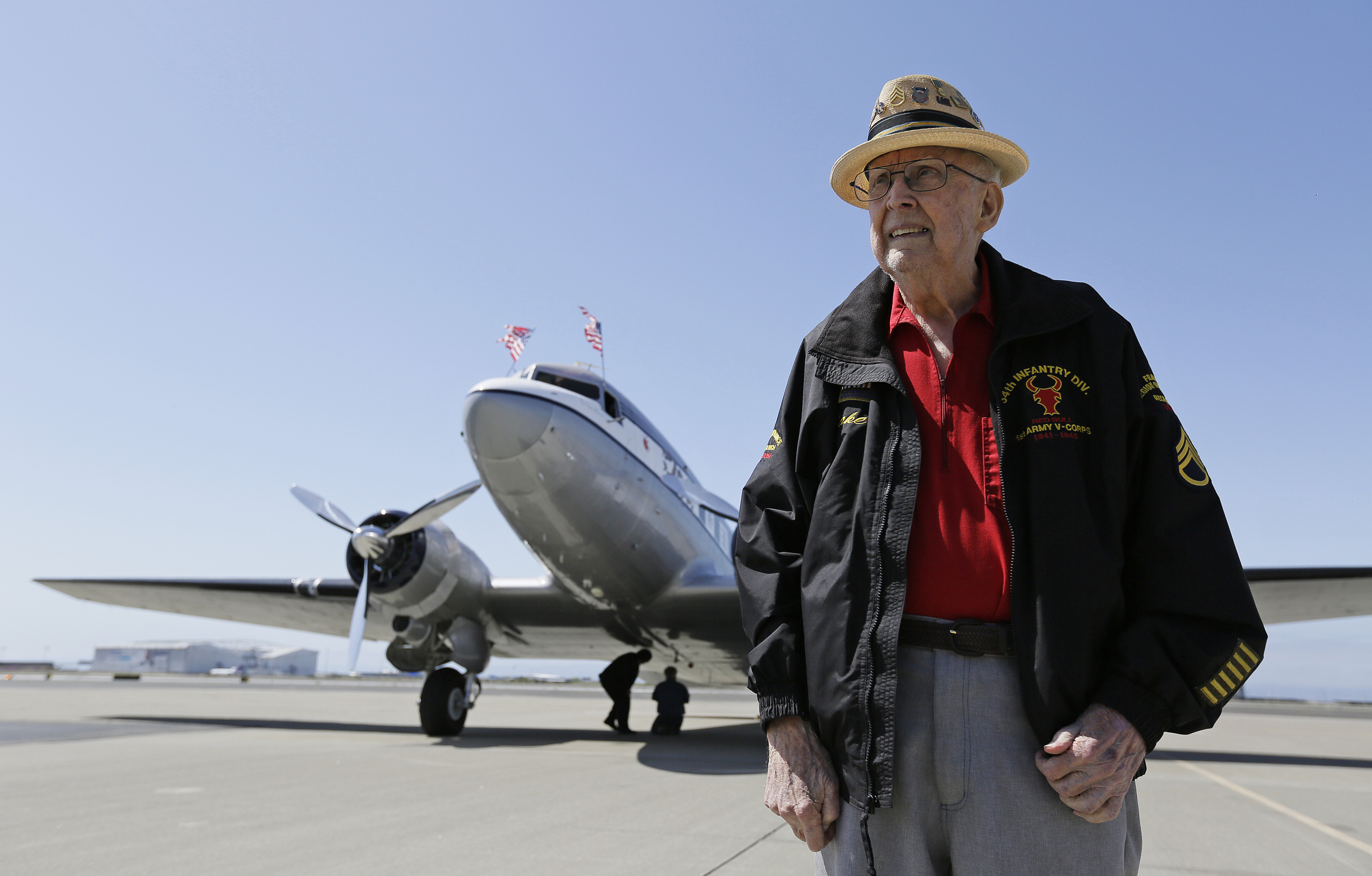 FILE - In this photo taken April 29, 2019, D-Day veteran Jake Larson poses before going for a ride in the "The Spirit of Benovia" World War II-era aircraft in Oakland, Calif. (AP Photo/Eric Risberg, file)