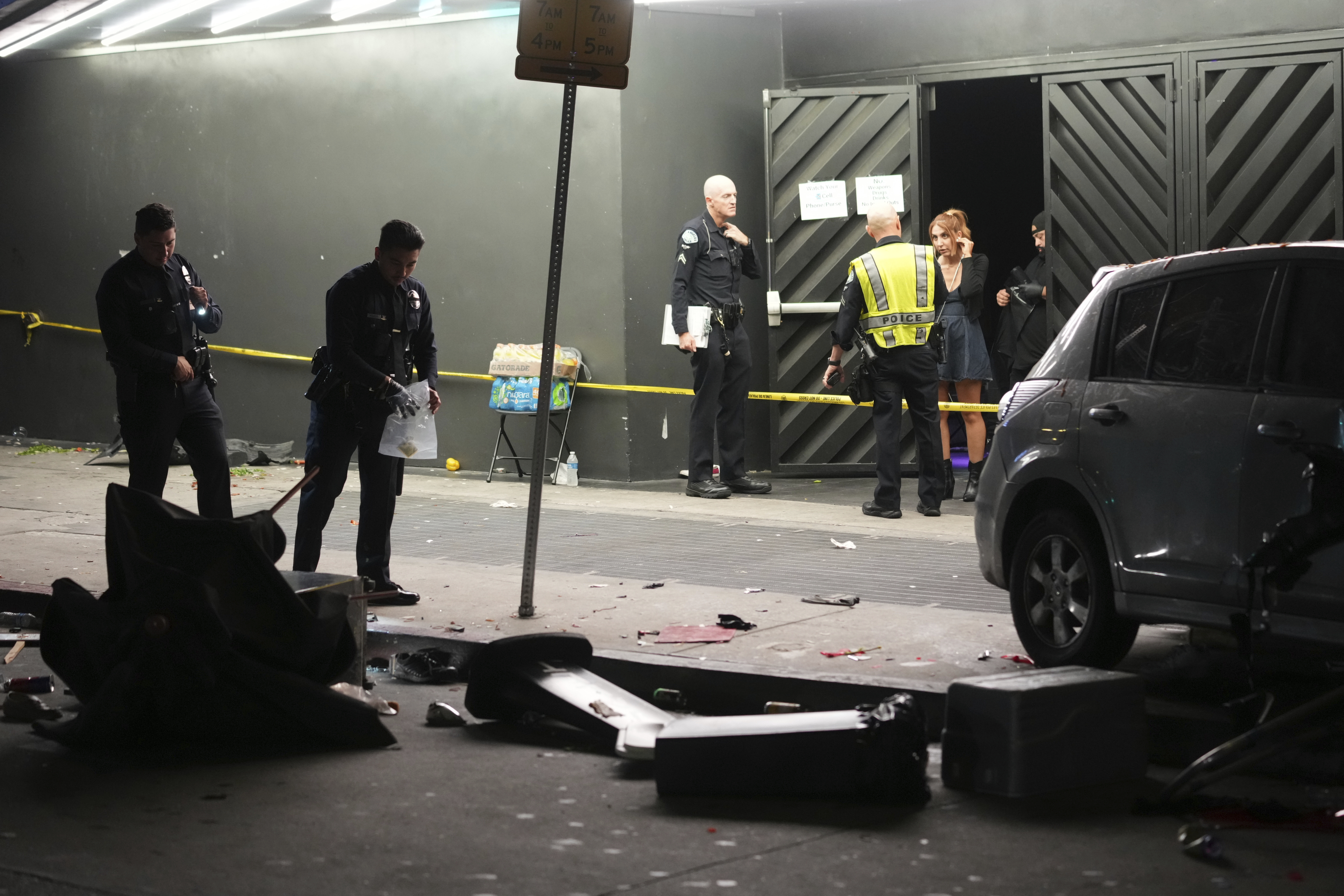 Law enforcement investigate the scene where a vehicle rammed into a crowd of people waiting to enter a nightclub along a busy boulevard in Los Angeles early Saturday, July 19, 2025 injuring several people. (AP Photo/Damian Dovarganes)