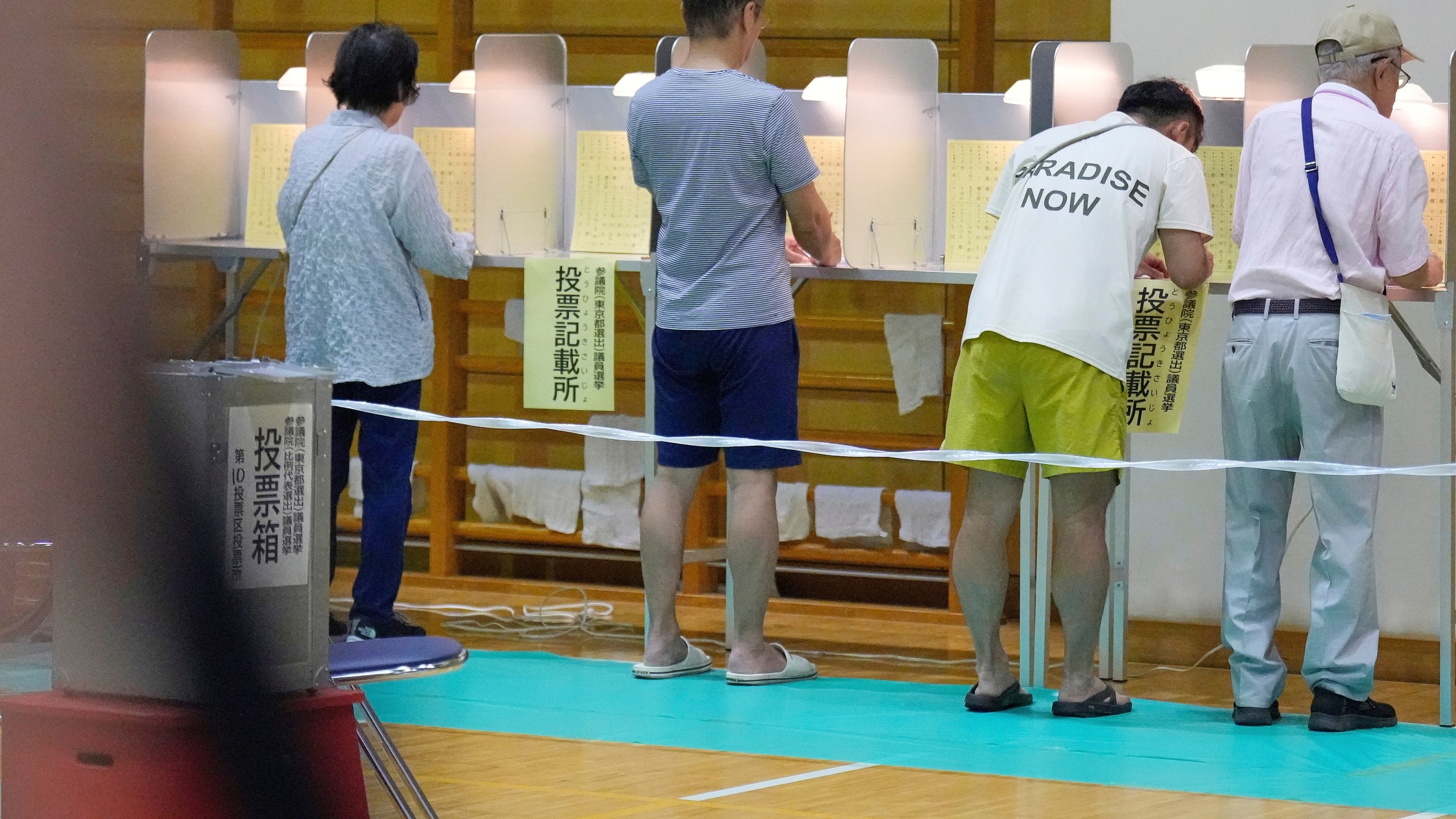 Voters fill in their ballots in the upper house election at a polling station Sunday, July 20, 2025, in Tokyo. (AP Photo/Eugene Hoshiko)