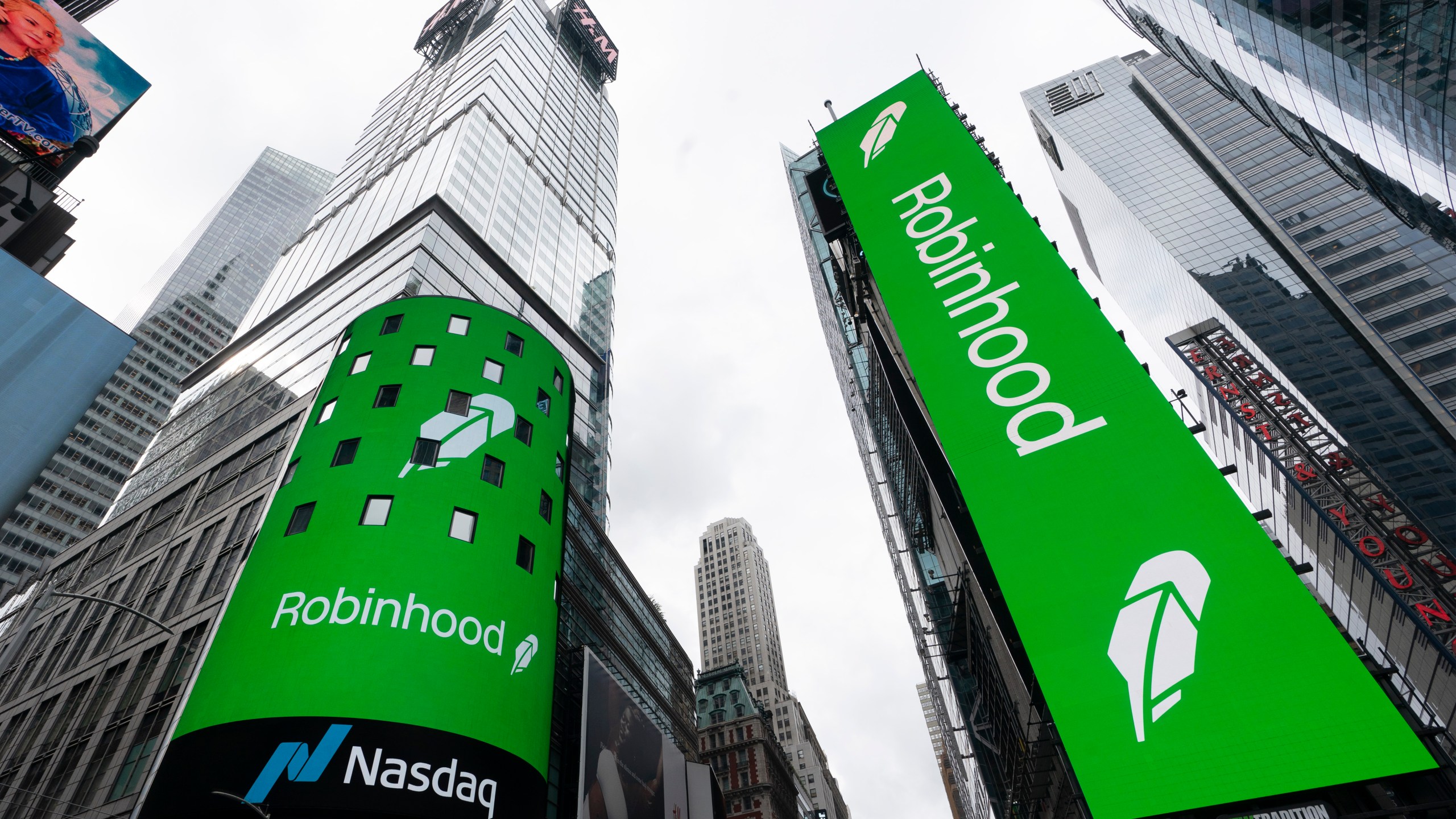 FILE - Electronic screens in New York's Times Square announce the Robinhood IPO, July 29, 2021. (AP Photo/Mark Lennihan, File)