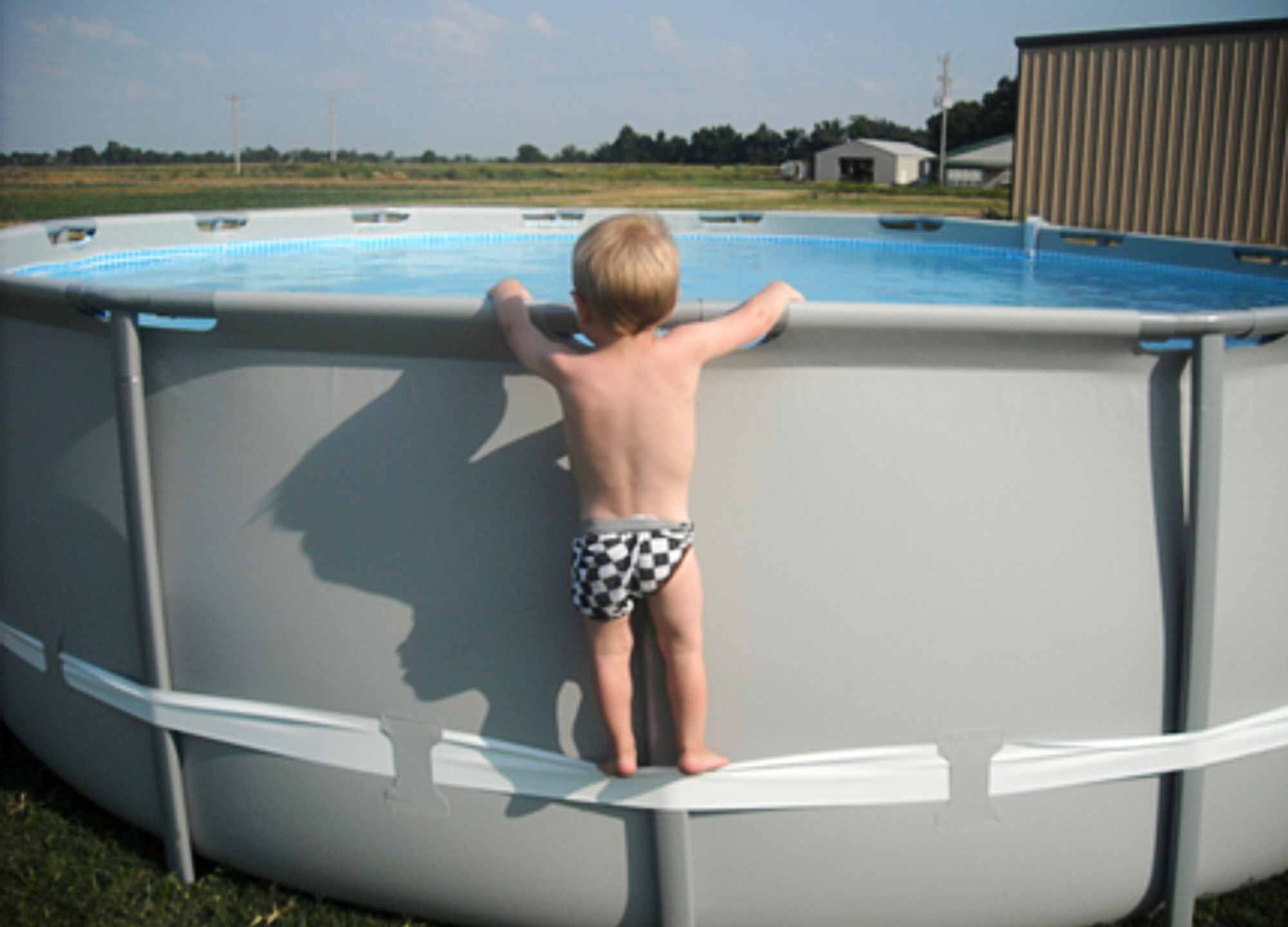 In this undated image provided by the CPSC, a child uses the compression strap to stand on above-ground pool. (CPSC via AP)