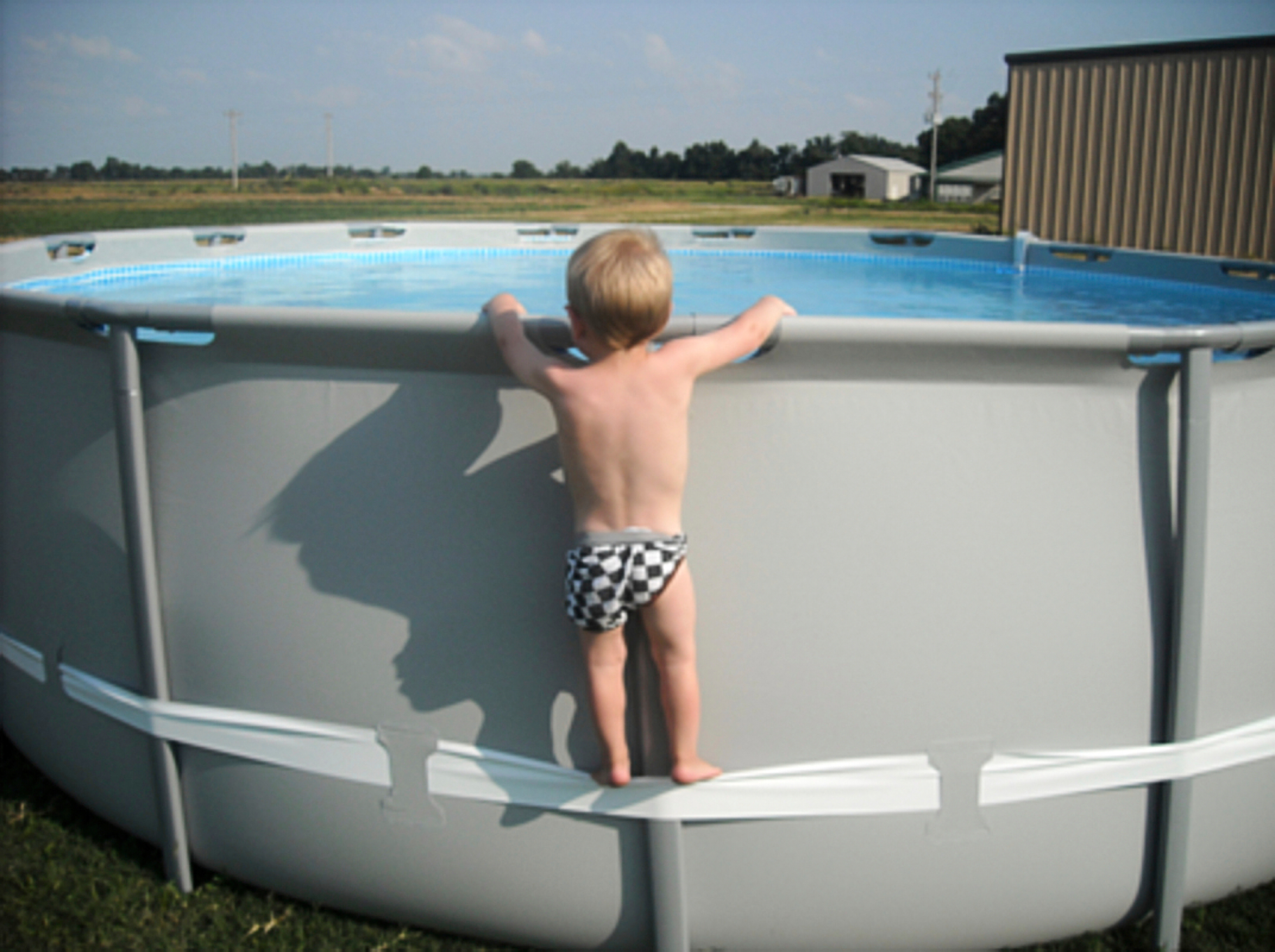 In this undated image provided by the CPSC, a child uses the compression strap to stand on above-ground pool. (CPSC via AP)
