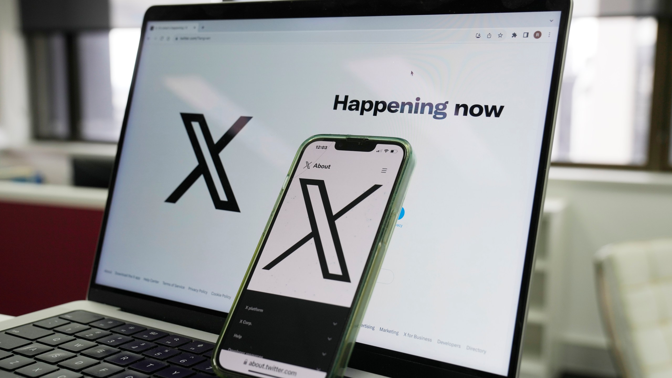 FILE - The opening page of X is displayed on a computer and phone, Oct. 16, 2023, in Sydney. (AP Photo/Rick Rycroft, File)