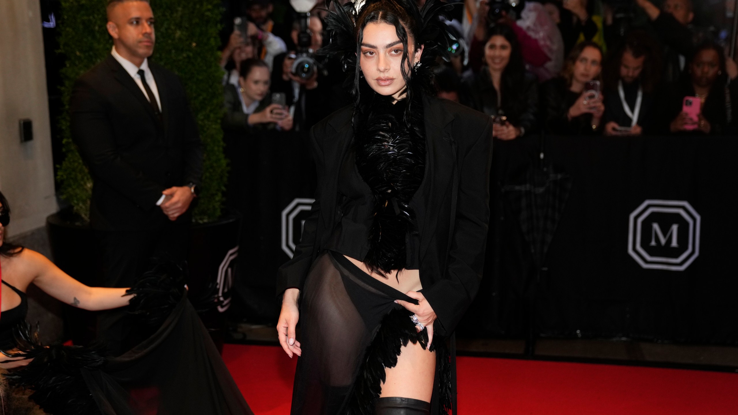 FILE - Charli xcx departs The Mark Hotel prior to attending The Metropolitan Museum of Art's Costume Institute benefit gala celebrating the opening of "Superfine: Tailoring Black Style" on Monday, May 5, 2025, in New York. (Photo by Charles Sykes/Invision/AP, file)