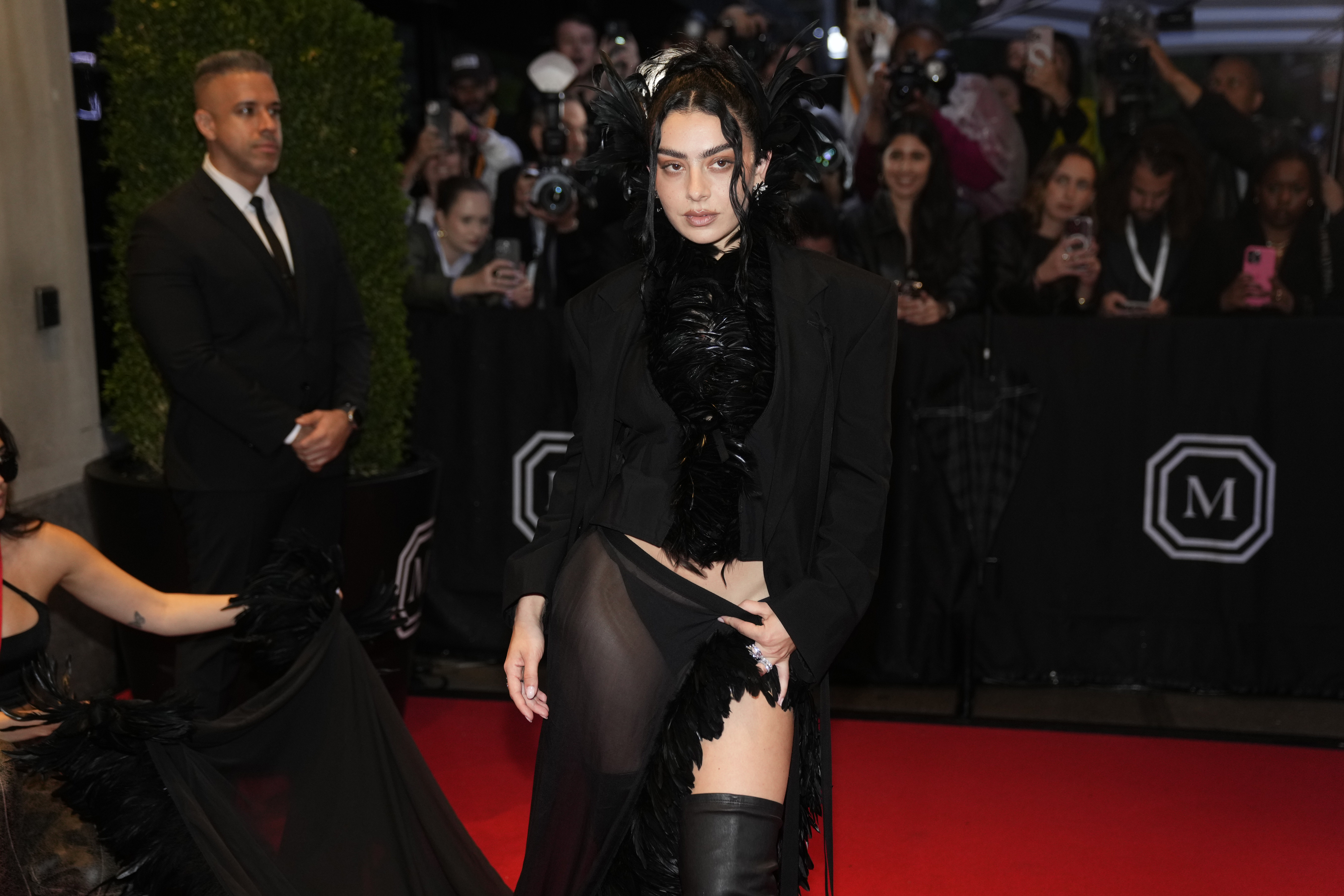 FILE - Charli xcx departs The Mark Hotel prior to attending The Metropolitan Museum of Art's Costume Institute benefit gala celebrating the opening of "Superfine: Tailoring Black Style" on Monday, May 5, 2025, in New York. (Photo by Charles Sykes/Invision/AP, file)
