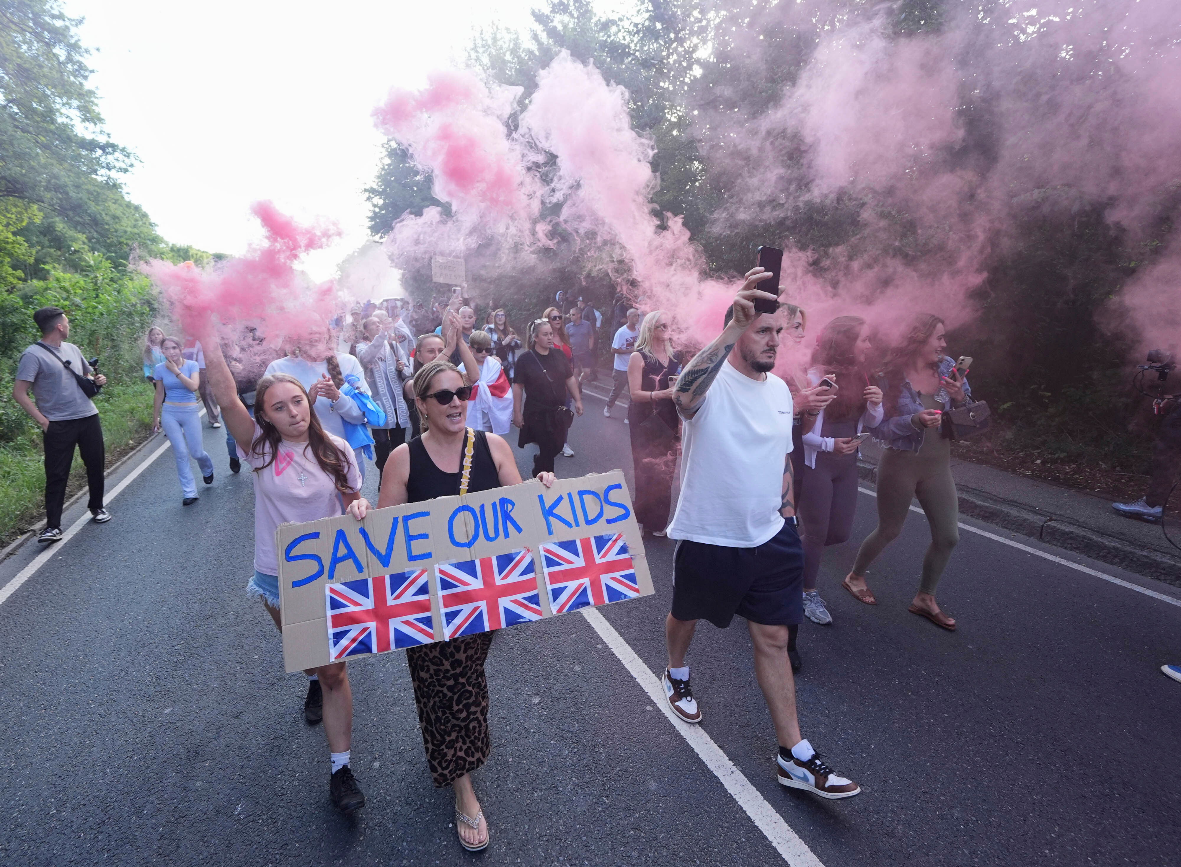 Protesters demonstrate near the Bell Hotel in Epping, northeast of London, Sunday, July 20, 2025. (Yui Mok/PA via AP)