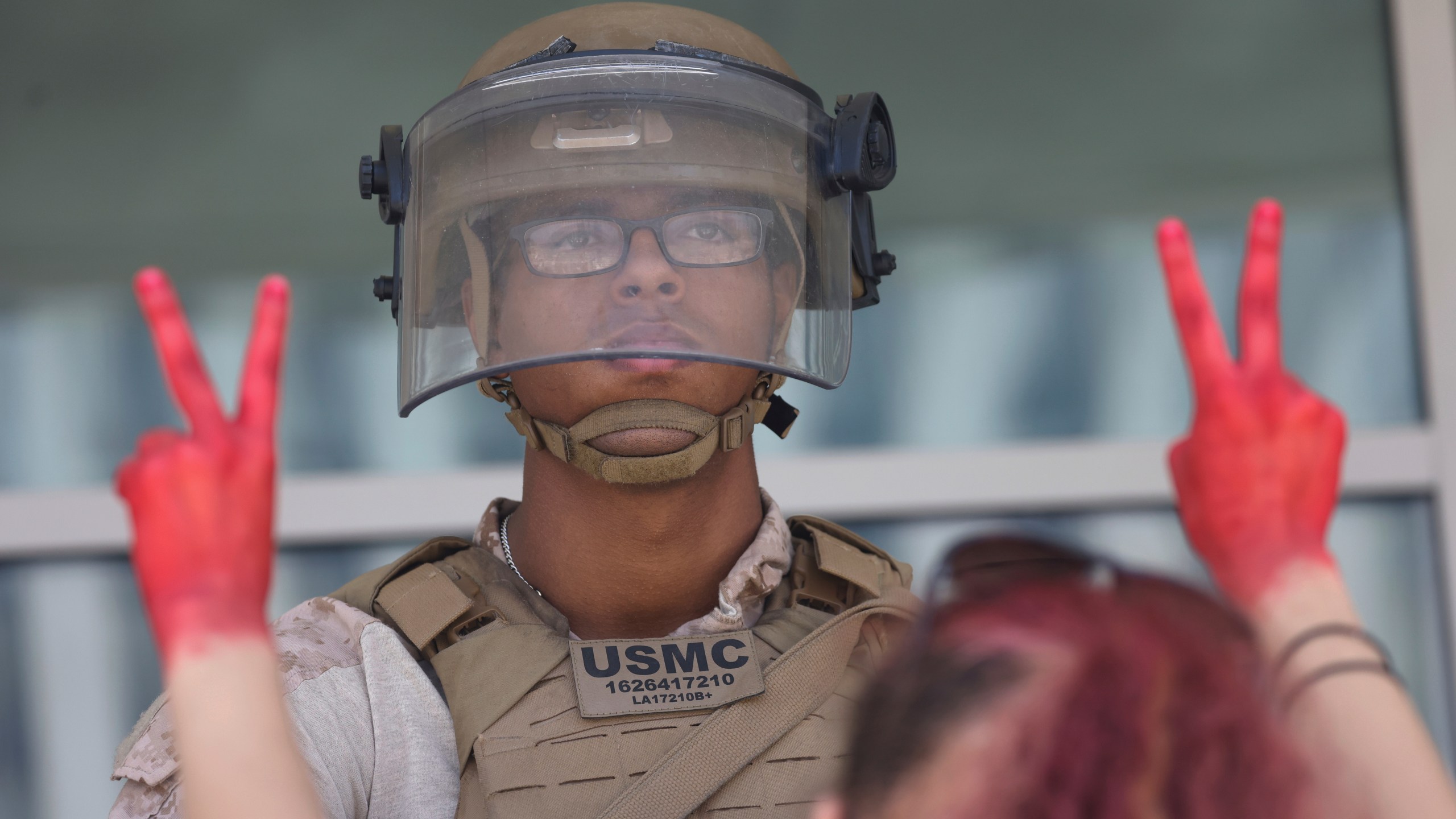 Protesters confront Marines outside the Federal Building on Friday, July 4, 2025 in Los Angeles. (AP Photo/Jill Connelly)